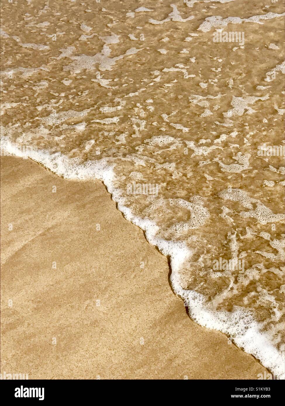 Sea wave on wet sand. - Smartphone Captured Stock Image