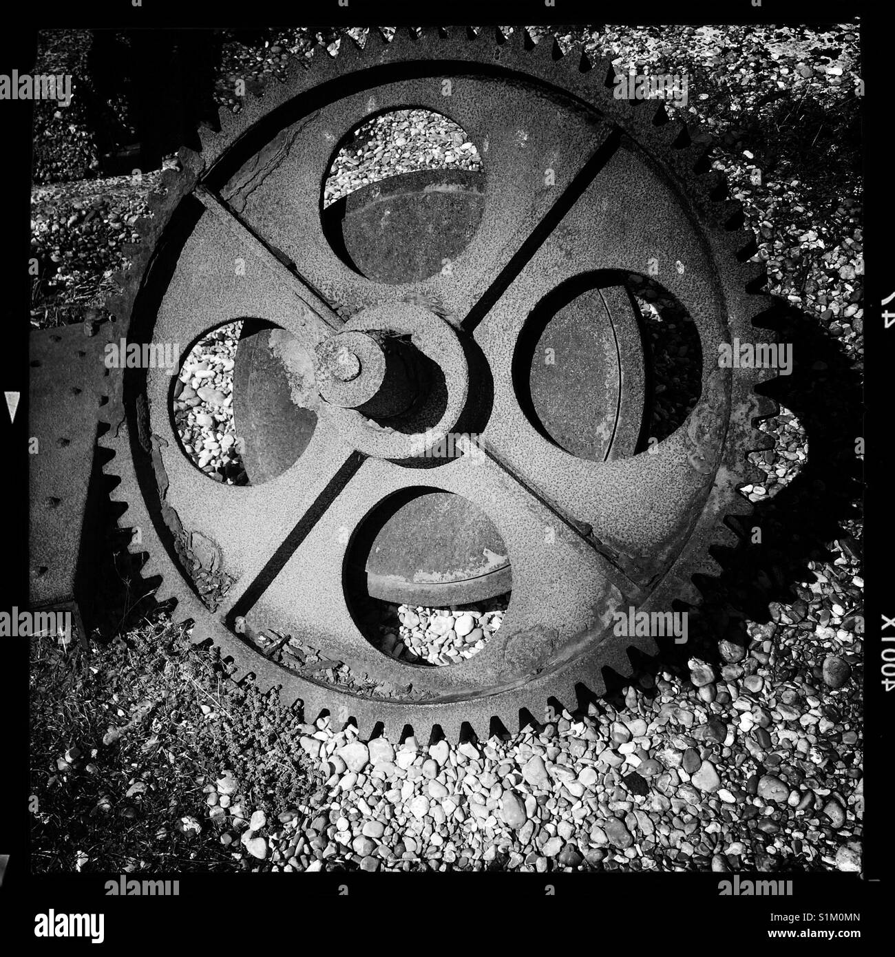 Old rusted cog wheel abandoned on Dungeness beach - Smartphone Captured Stock Image