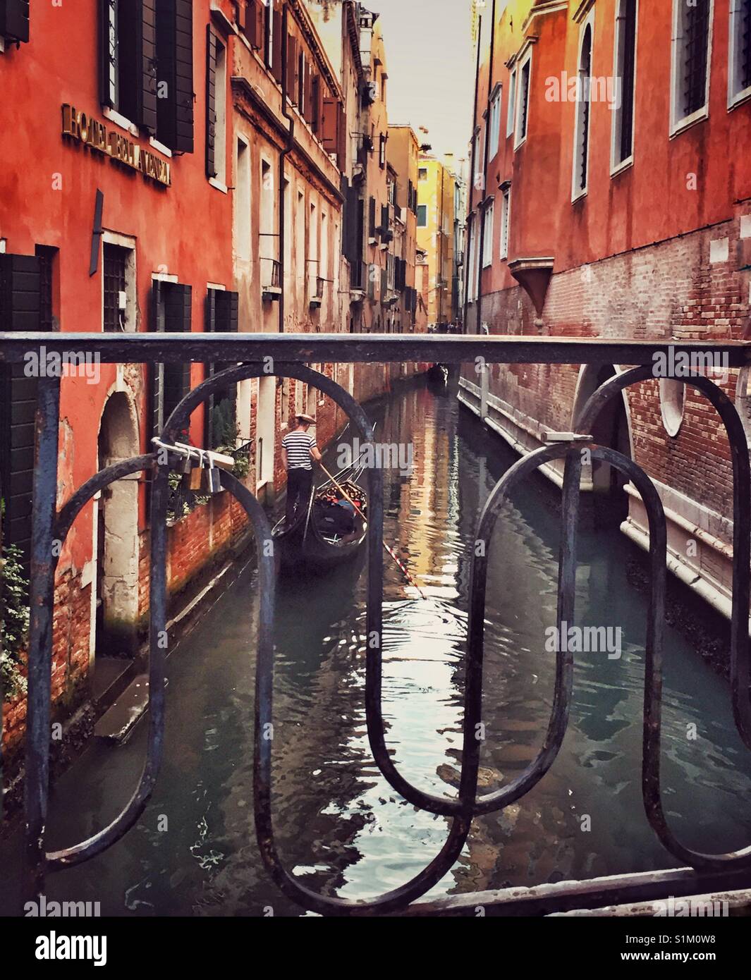 Gondola on narrow canal in Venice, Italy. Stock Photo