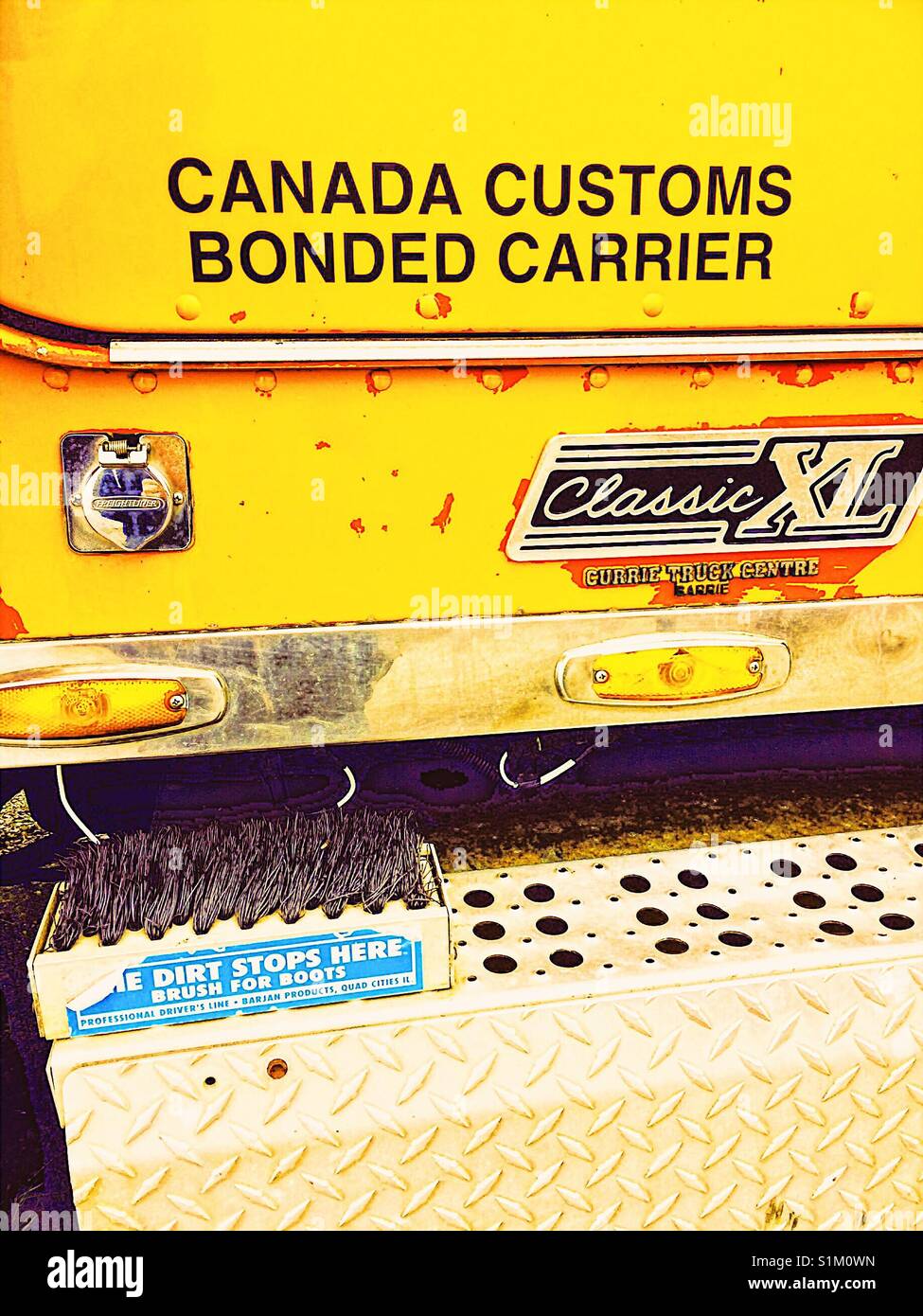 Boot brush attached to yellow American Classic XL Freightliner truck