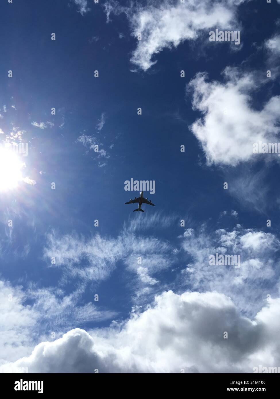 Emirates Dreamliner flying in. blue sky - Smartphone Captured Stock Image Emirates Dreamliner flying in. blue sky - Smartphone Captured Stock Image