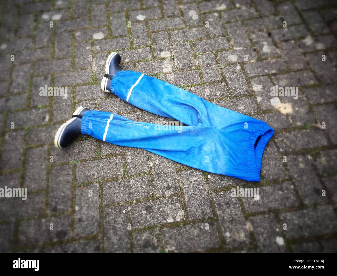 Blue Rain trousers with a pair of wellingtons Stock Photo