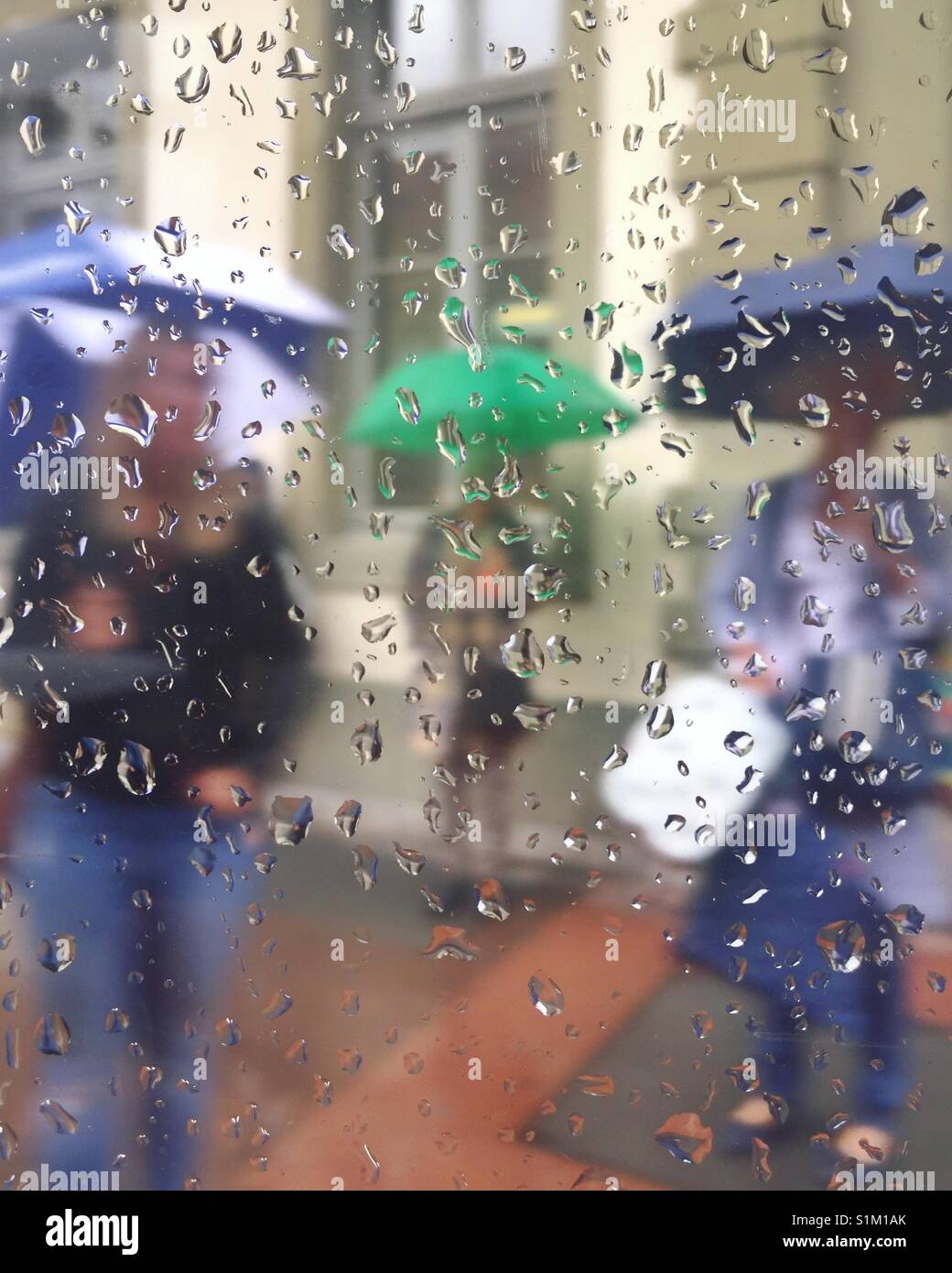 People holding umbrellas in the rain - Smartphone Captured Stock Image