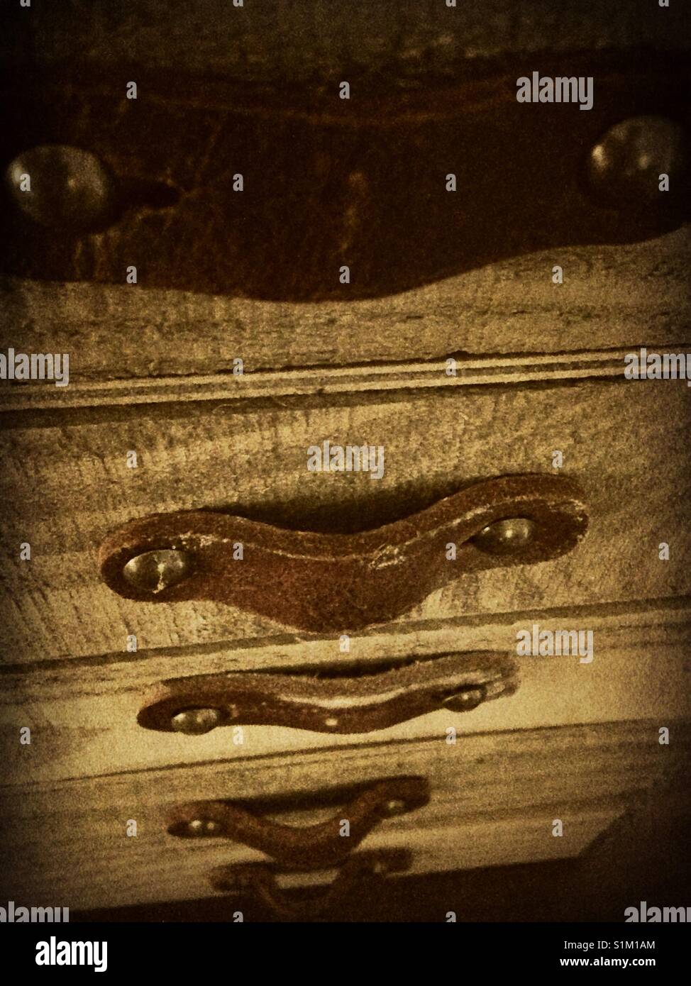 Downward view of stack of uniform wooden boxes with leather handles - Smartphone Captured Stock Image