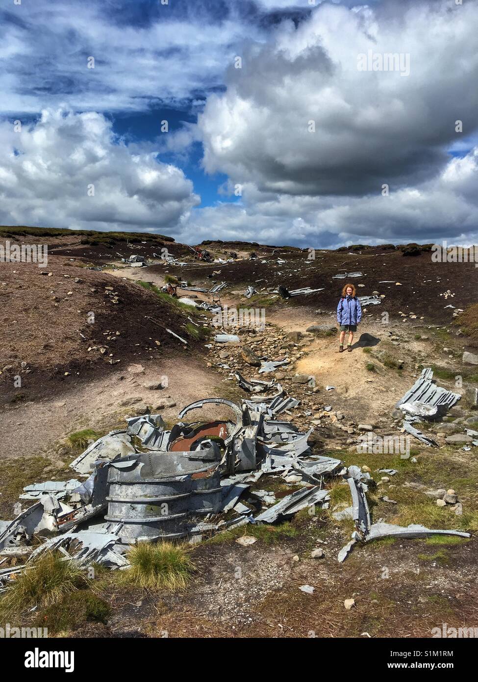 A woman stood at Boeing RB29 Superfortress aircraft crash site on Bleaklow Moor near Glossop Stock Photo