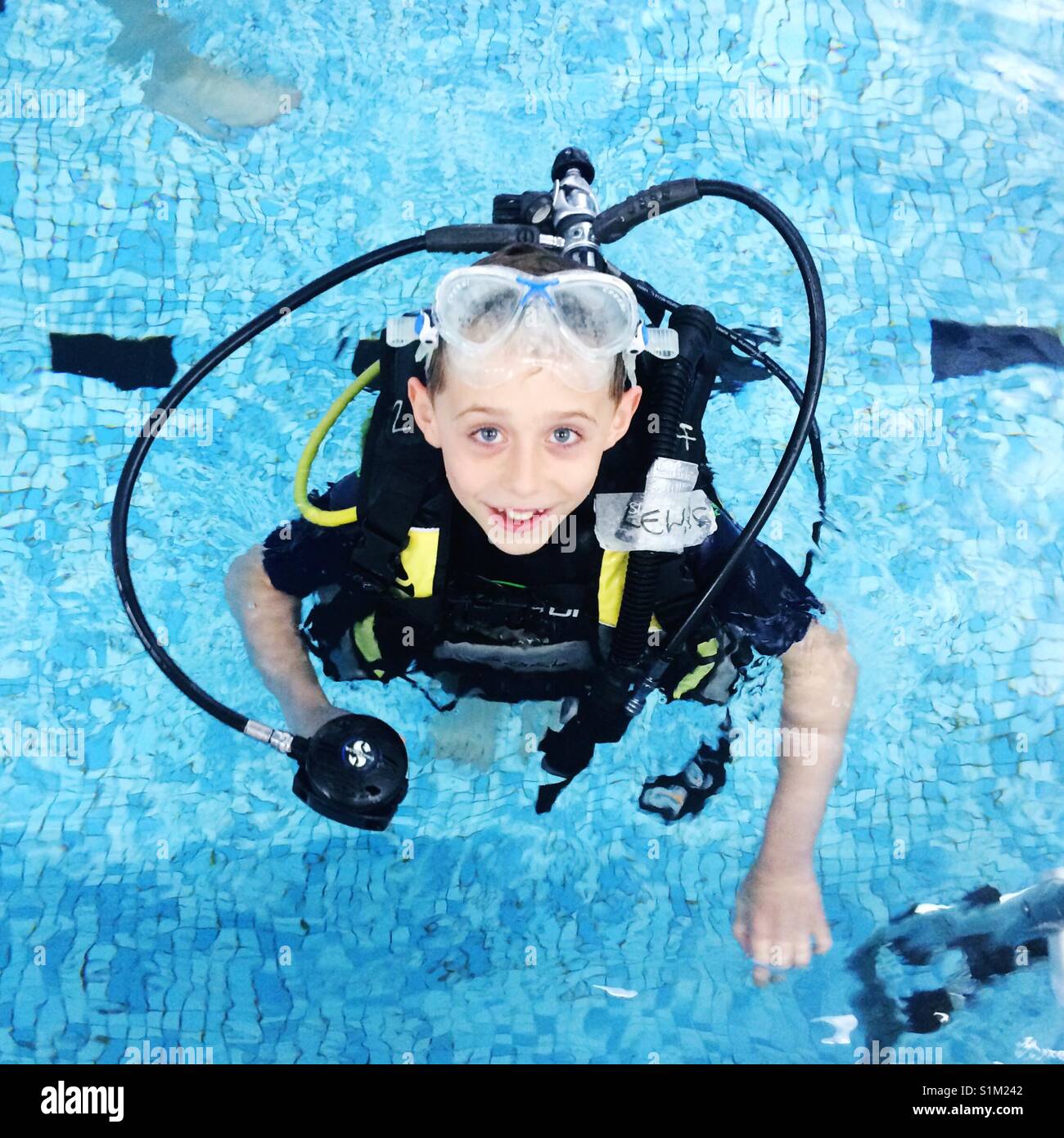 Eight year old boy scuba diving in a swimming pool, Hampshire, England