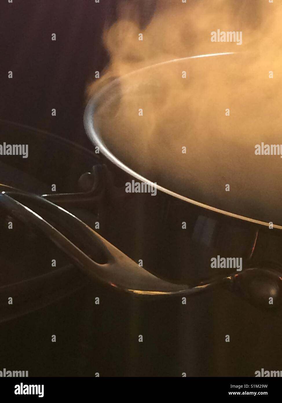 Pan of boiling water and steam Stock Photo