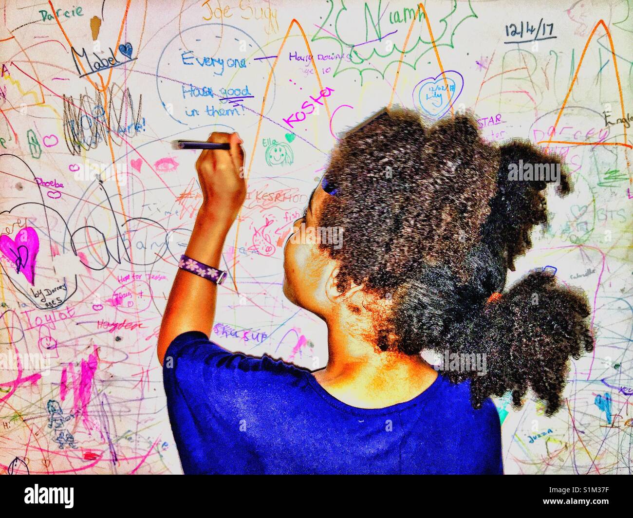 A young girl writing on a wall Stock Photo Alamy