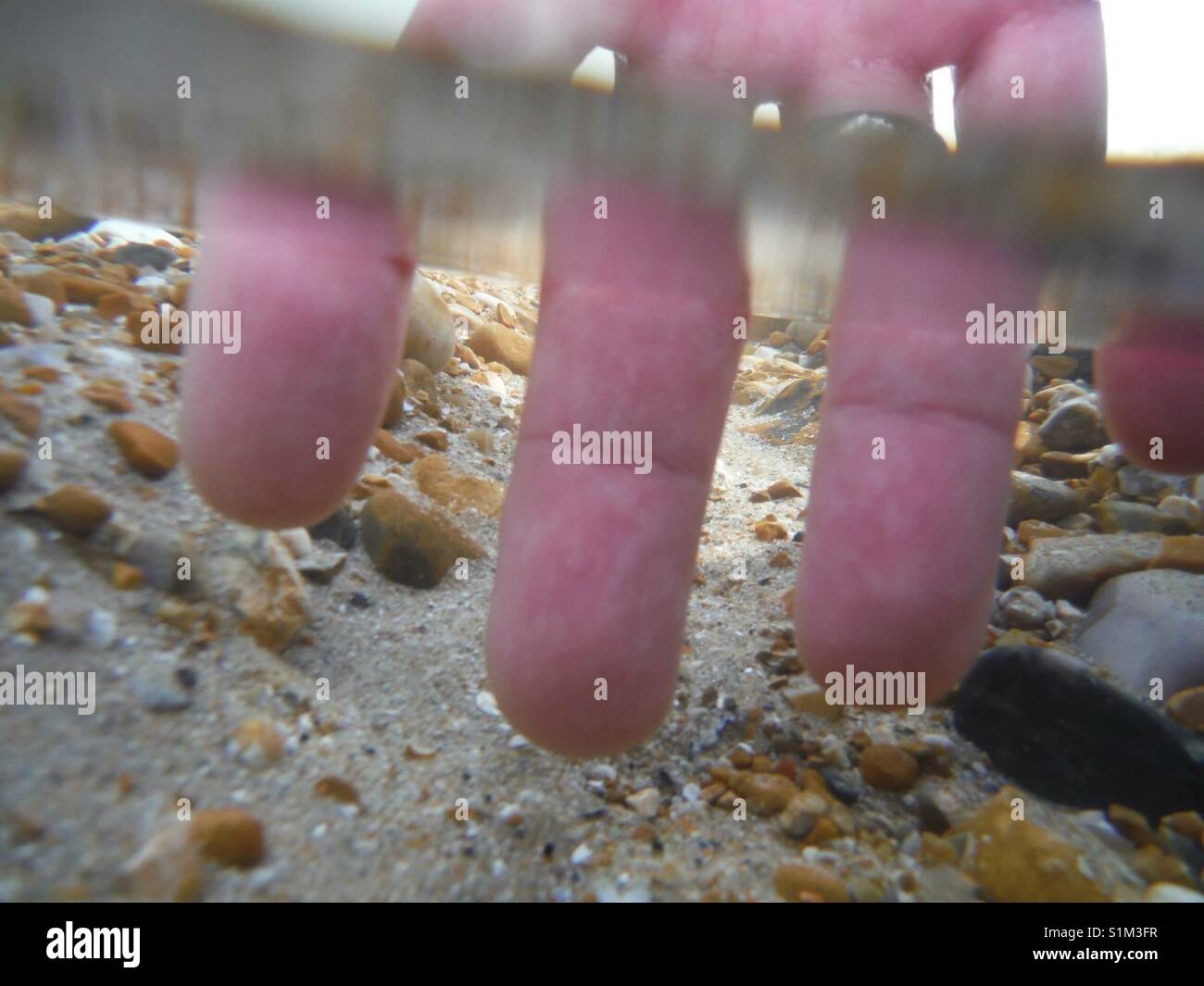 Fingers as seen from above and below water - Smartphone Captured Stock Image