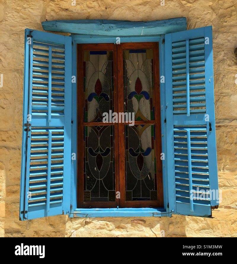 Blue shuttered window in Cyprus Stock Photo - Alamy