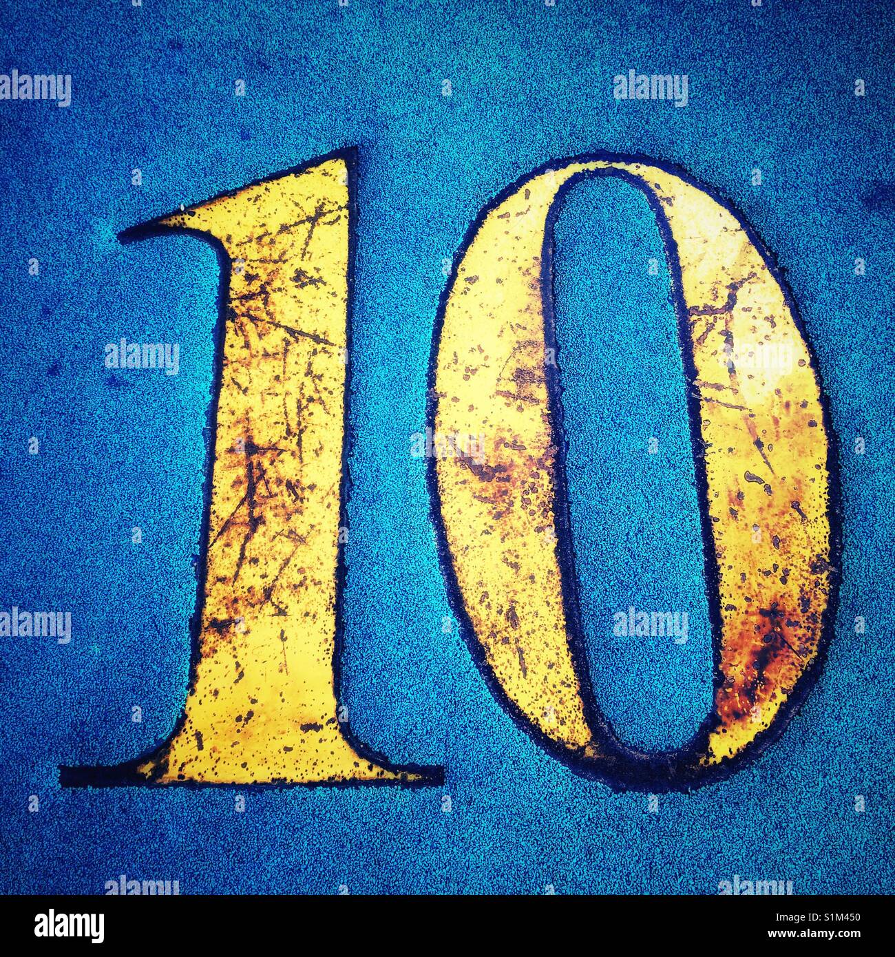 Golden number ten on blue background - Smartphone Captured Stock Image