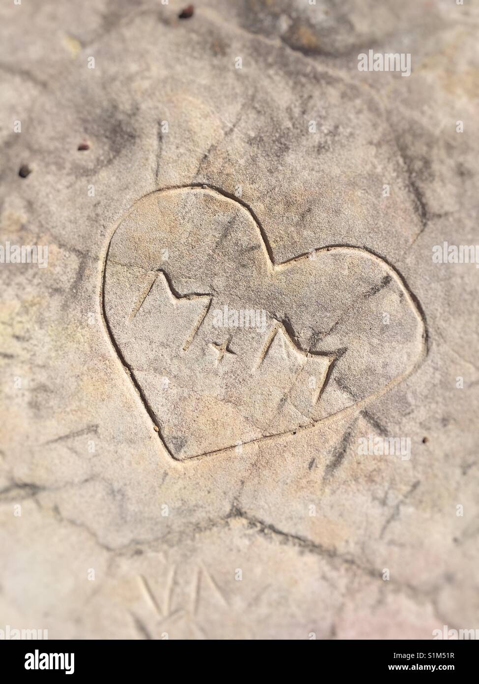 Love token engraved on a rock. Stock Photo