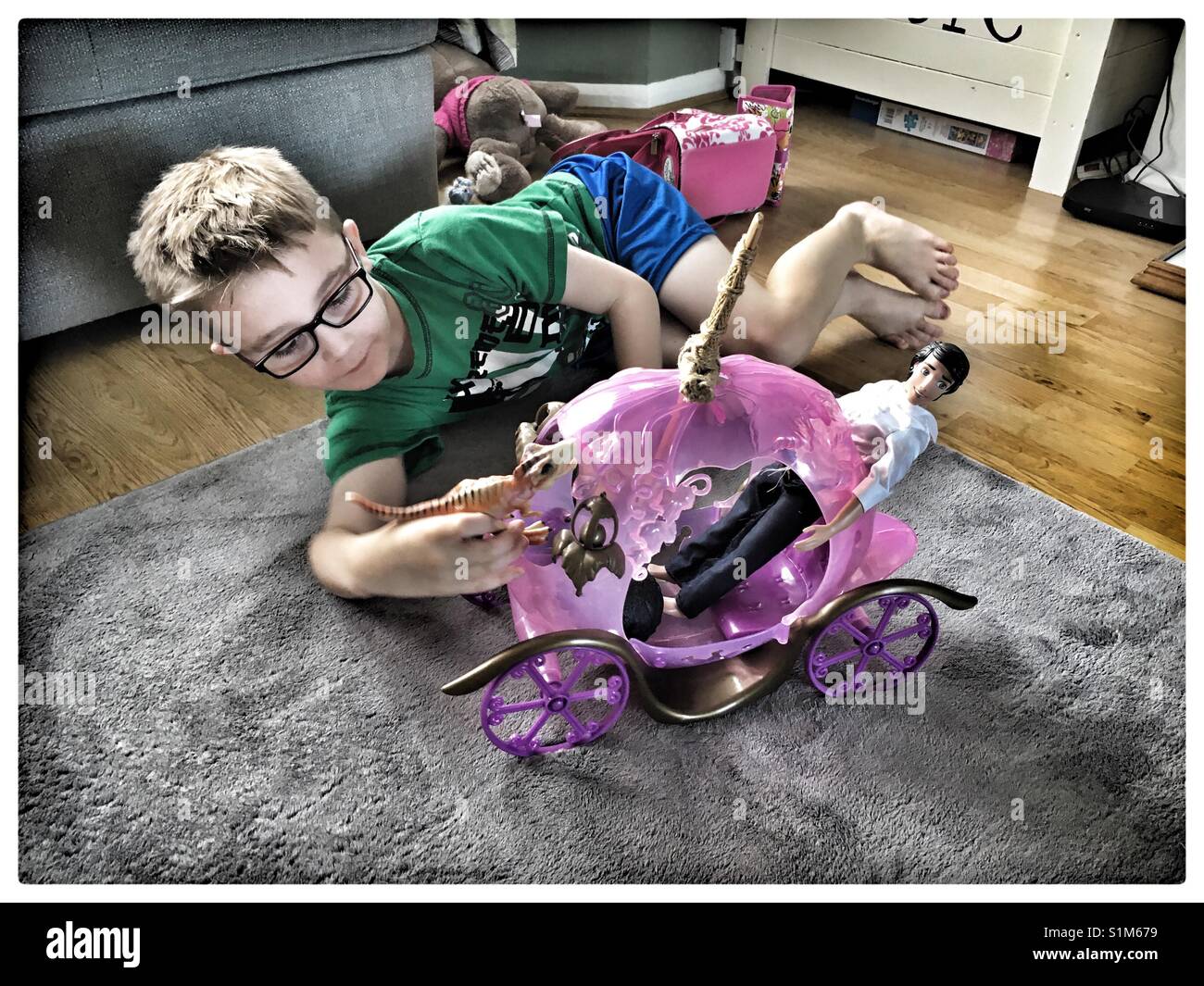 6 year old boy playing with Barbie Stage coach Stock Photo - Alamy