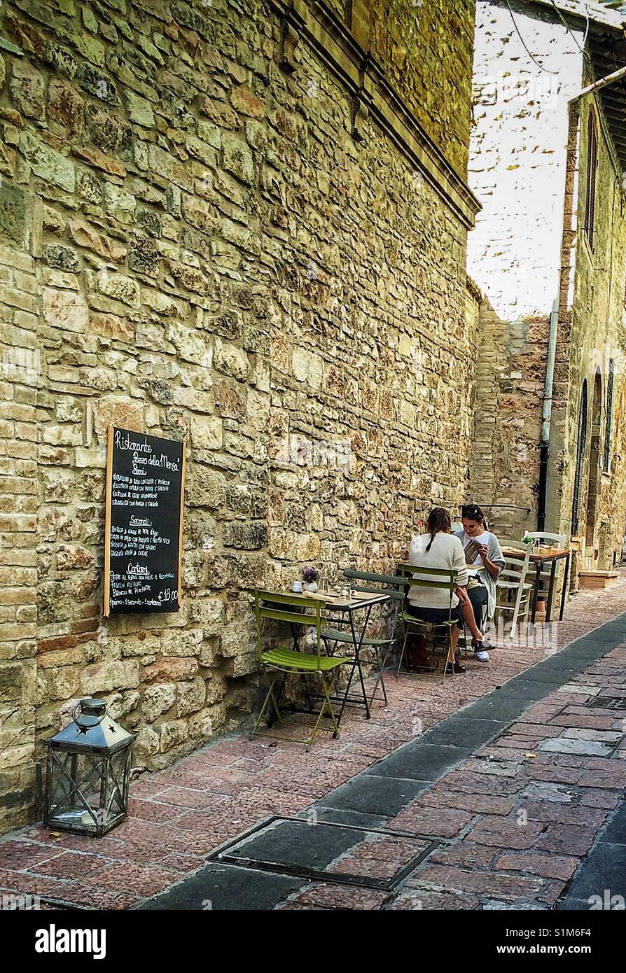 Two women having lunch at an outdoor terrace in Assisi, Italy. Stock Photo