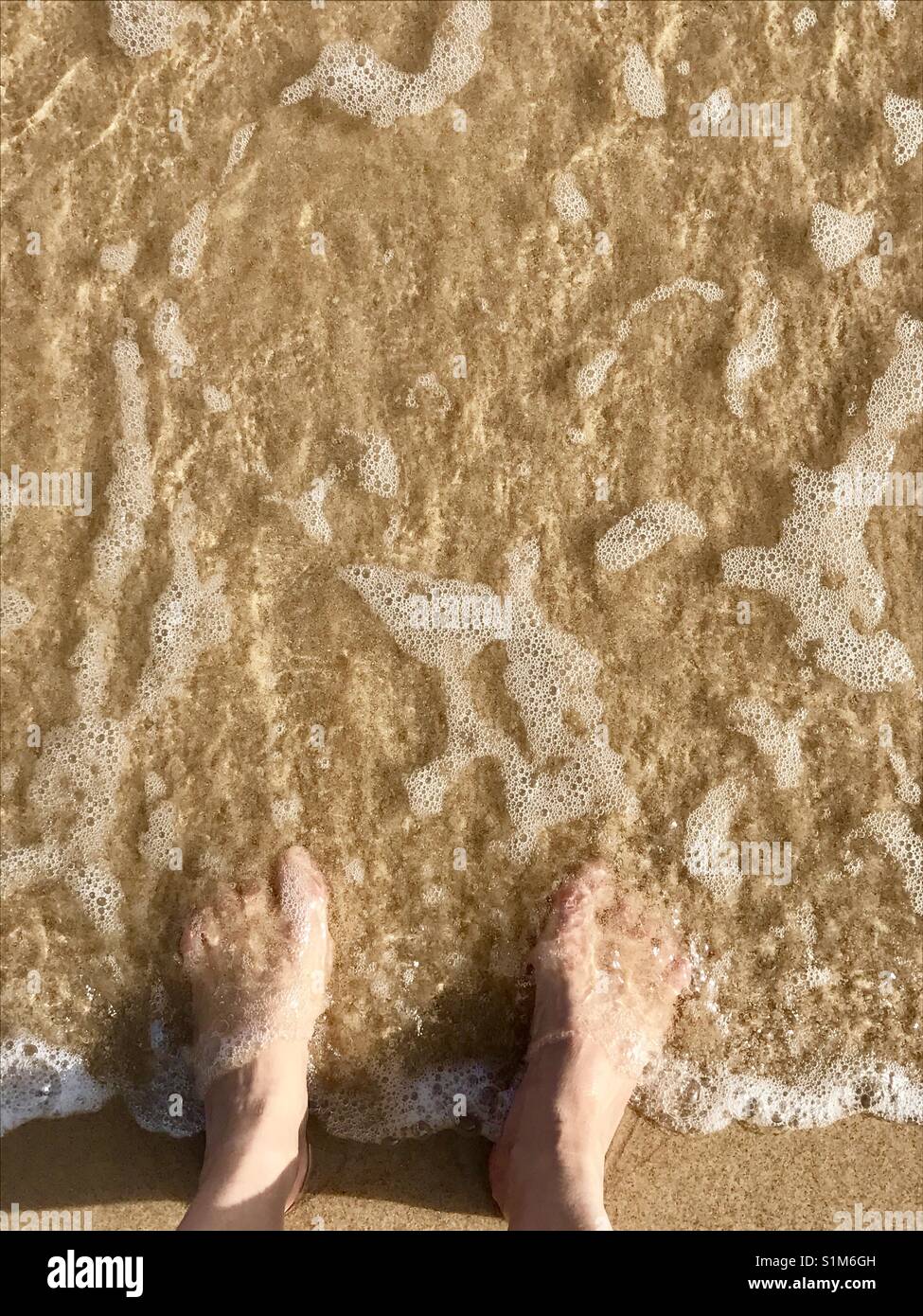 Woman's feet on the sea shore. - Smartphone Captured Stock Image
