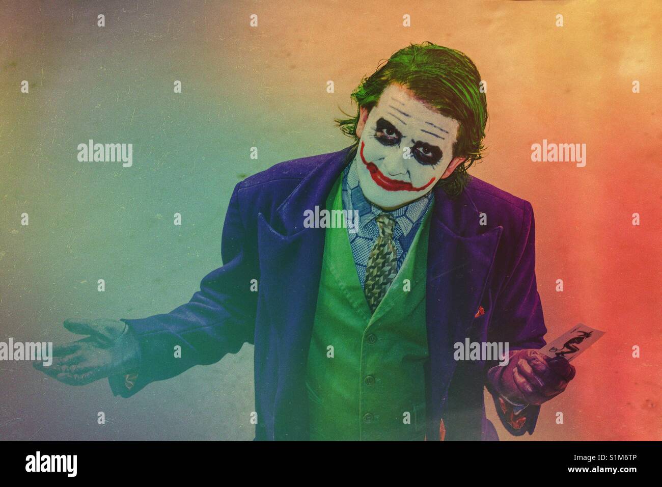The Joker from Batman The Dark Knight movie is a villain and bad guy who is portrayed by a cos play man at a comic con event Stock Photo