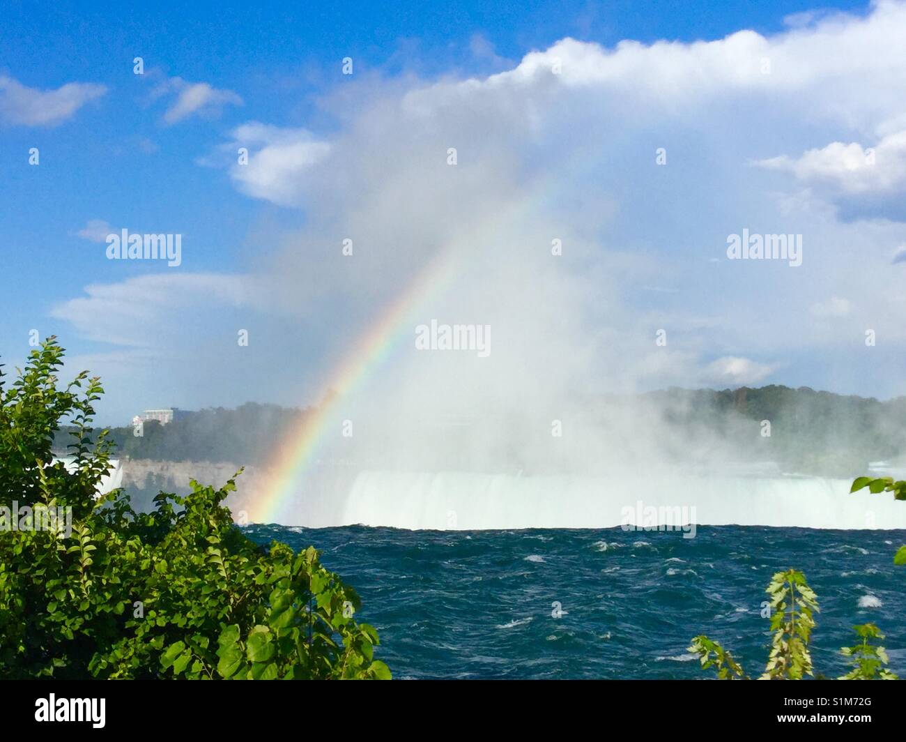 Rainbow appears out of the mist of the Horseshoe Falls, Ontario. - Smartphone Captured Stock Image