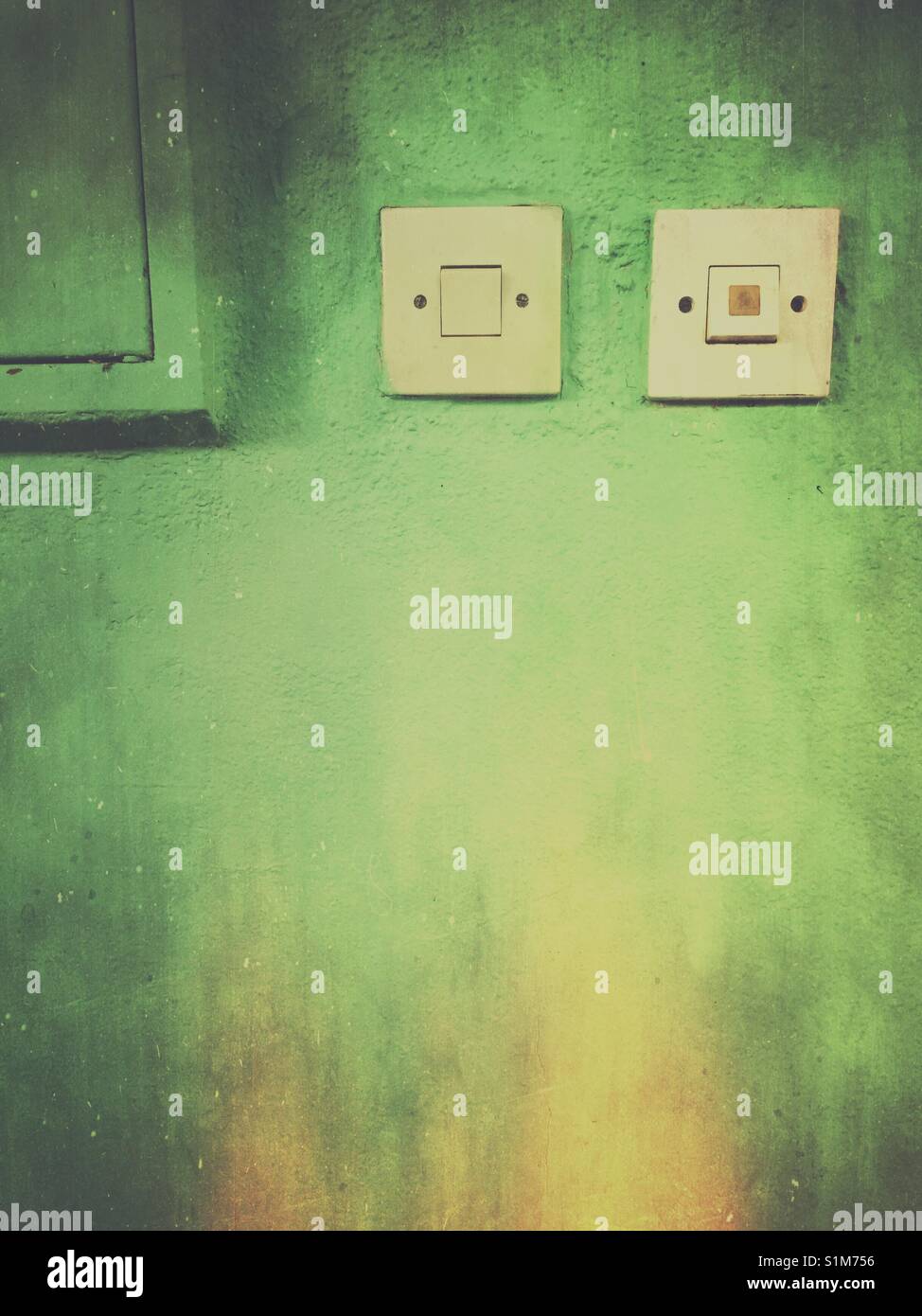 Electric light switches on green wall - Smartphone Captured Stock Image