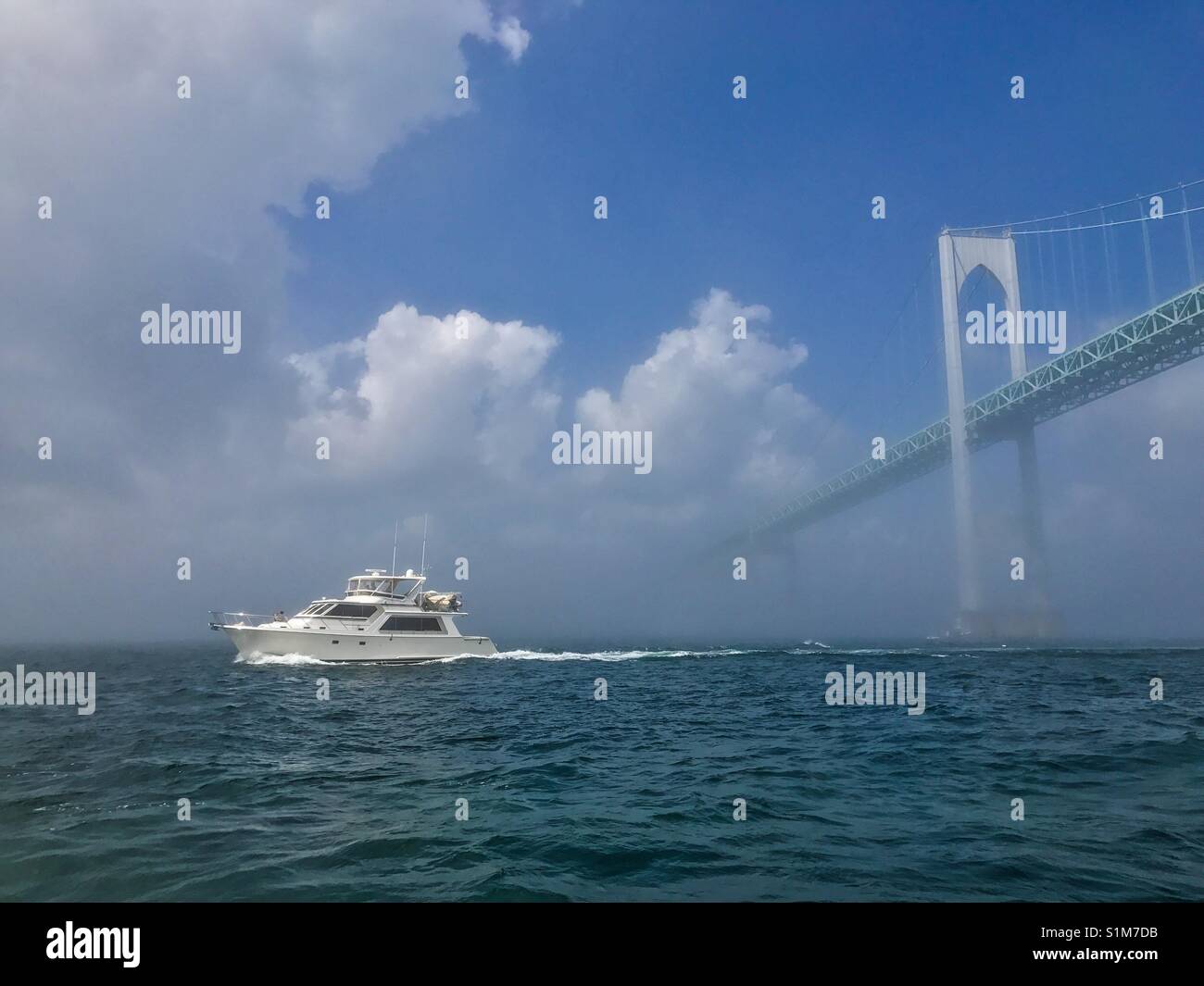 Boat traveling under the Newport , Rhode Island bridge. - Smartphone Captured Stock Image