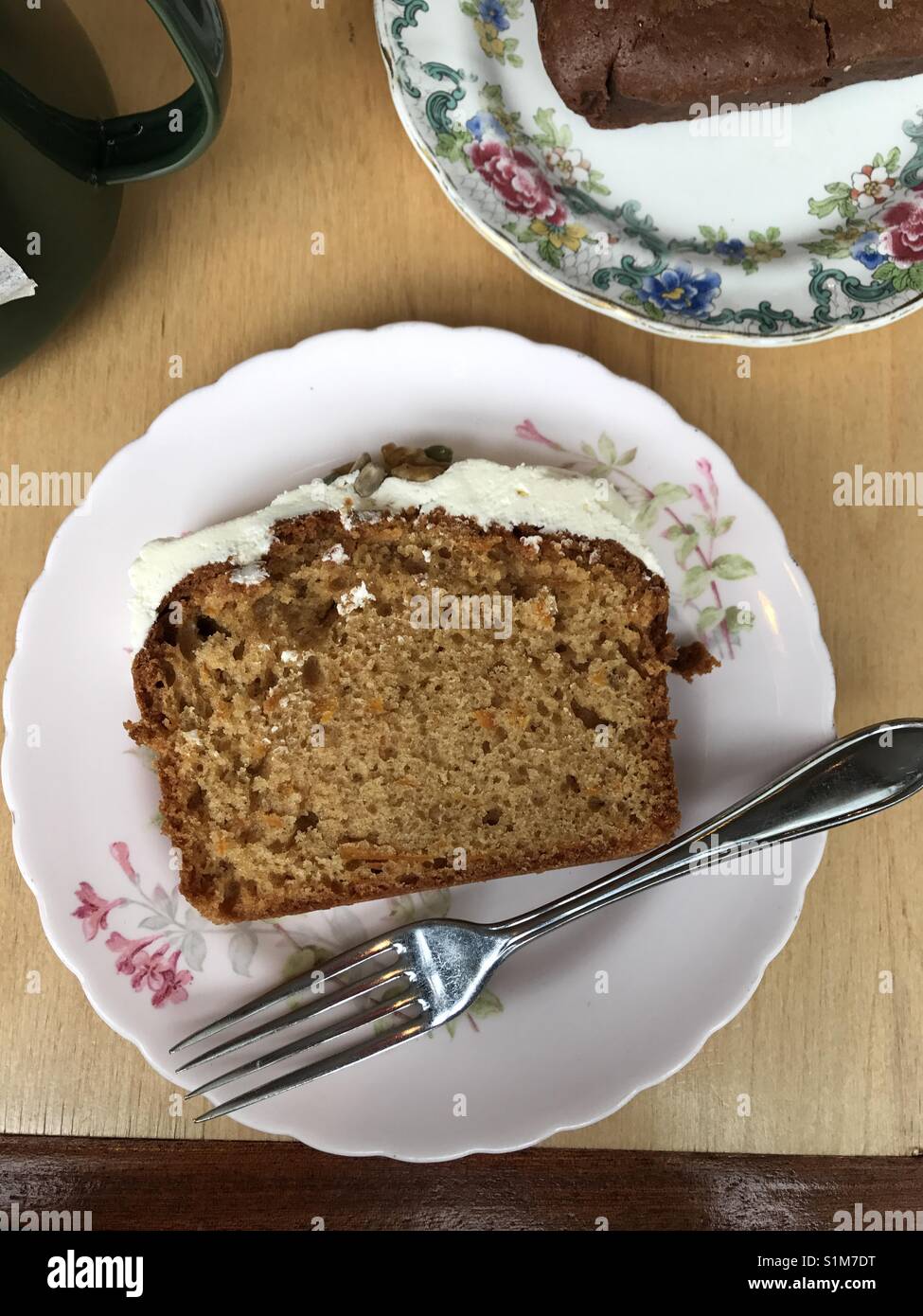 Slice of carrot cake on pretty vintage floral China plate with fork - Smartphone Captured Stock Image