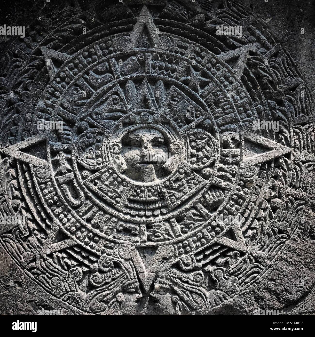 A reproduction of the Mexica Sun Calendar, known as the Aztec Calendar, is displayed in a house in Mexico City, Mexico - Smartphone Captured Stock Image