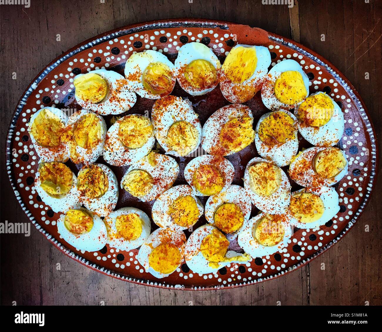 Organic free range eggs with red paprika pepper and olive oil from a Spanish recipe in a home in Mexico City, Mexico Stock Photo