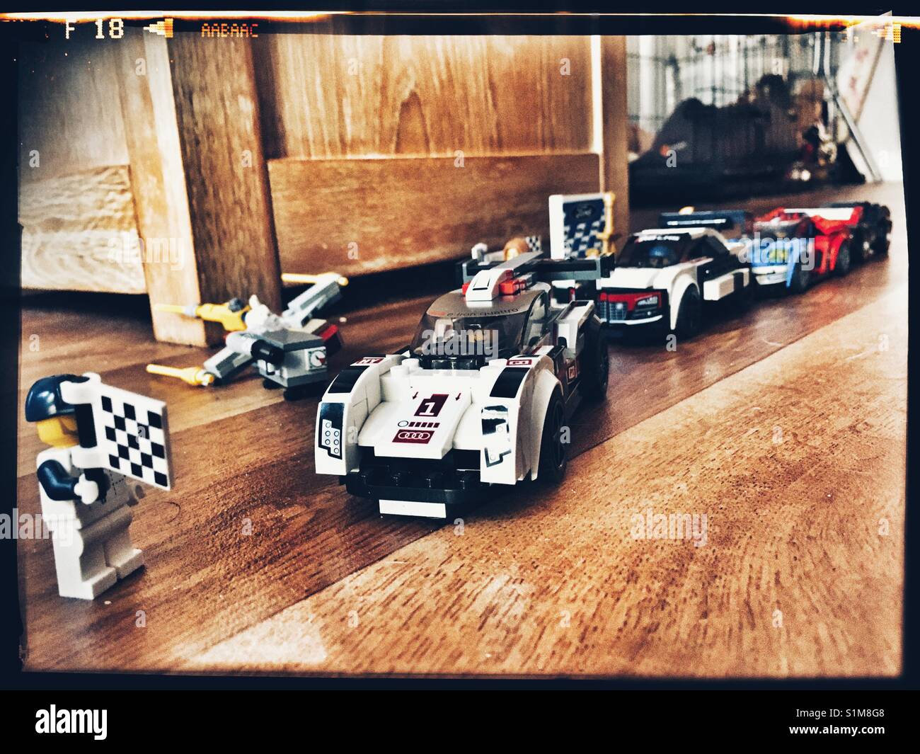 Lego racing cars lined up at the chequered flag. Stock Photo