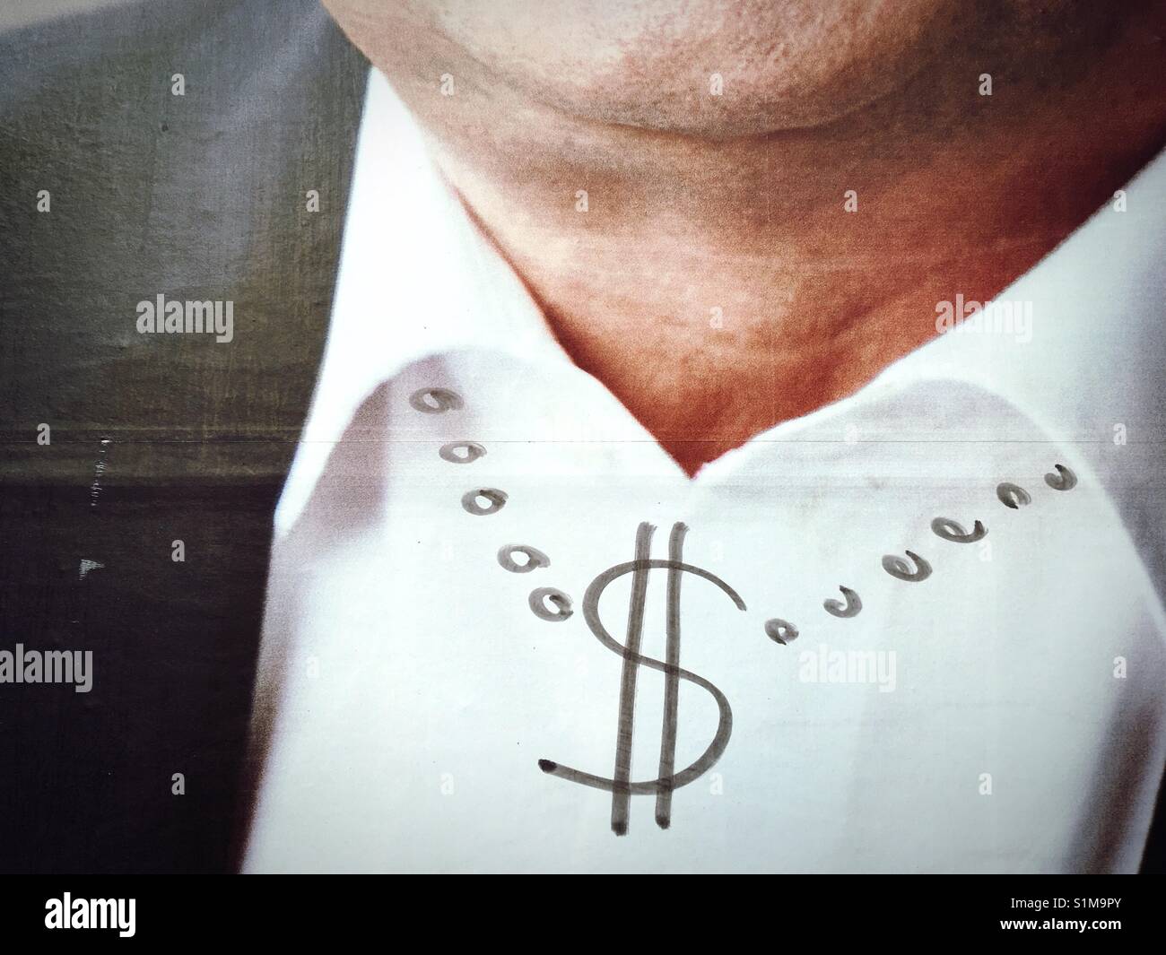 A picture of a man's collar and neck with a necklace and a dollar symbol drawn around his neck Stock Photo
