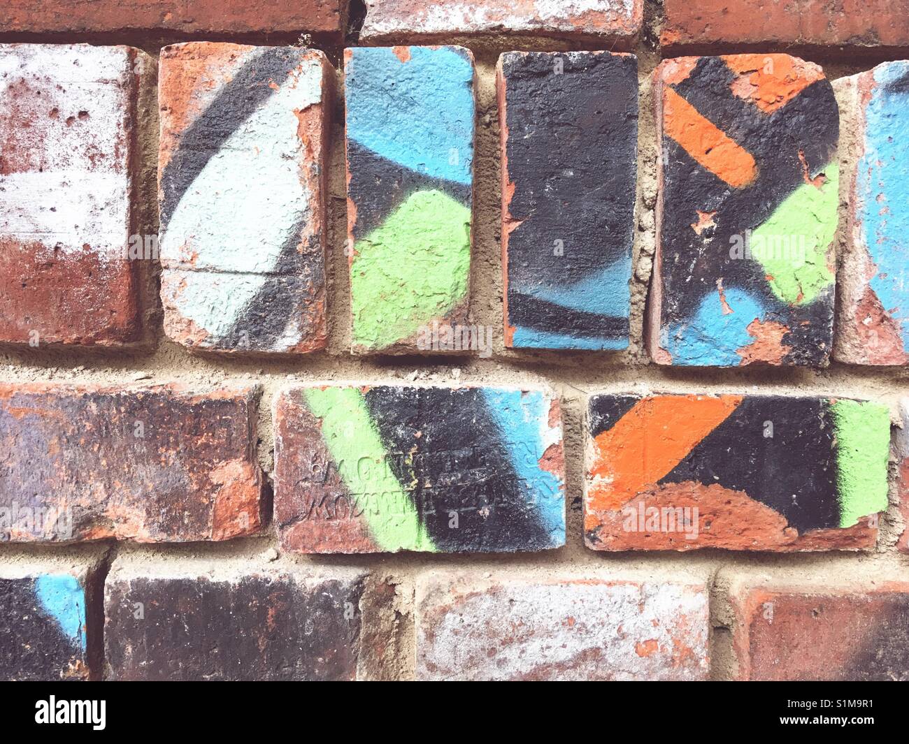 A brick wall with graffiti Stock Photo