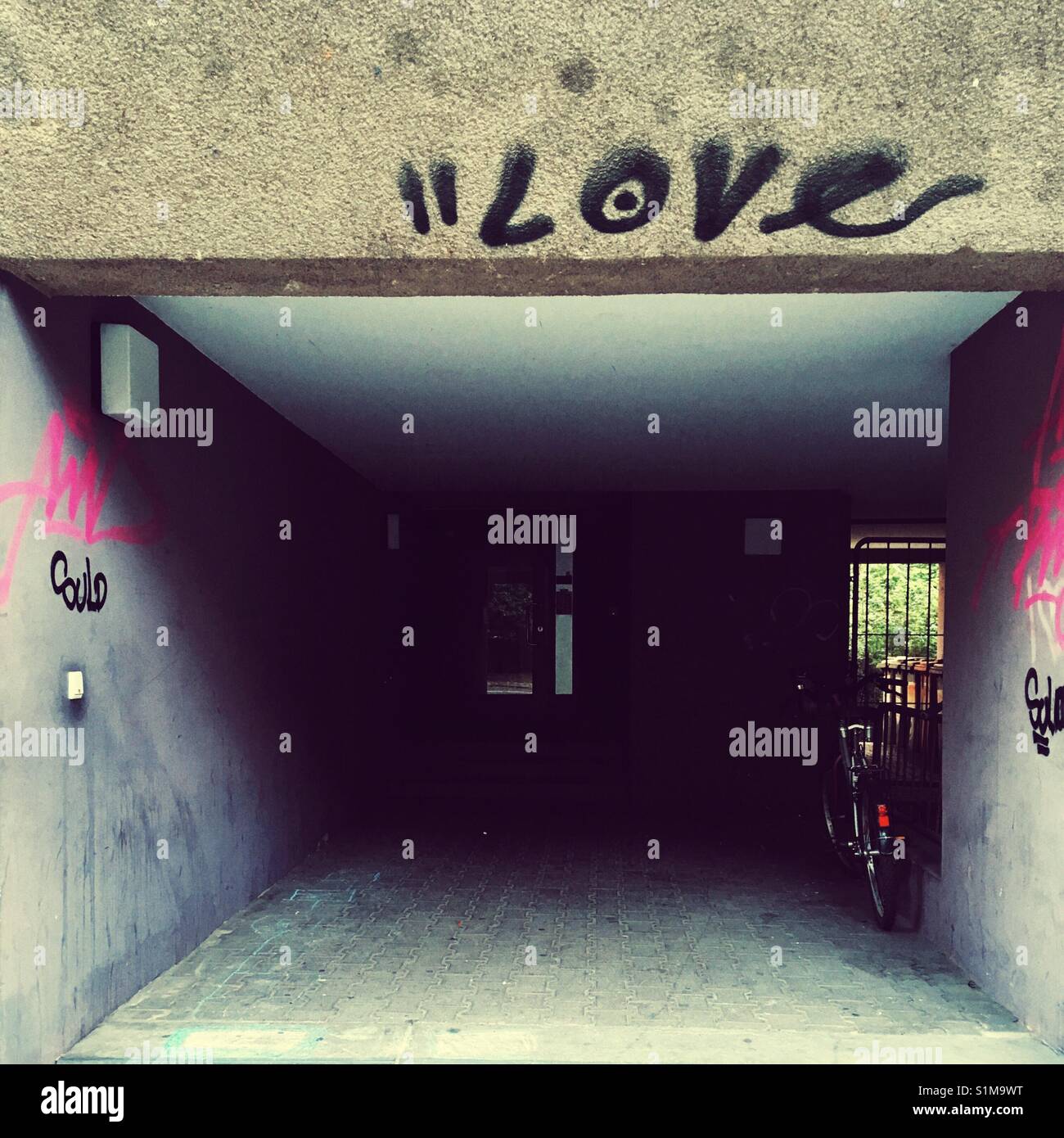 The word love written above the entrance to an urban apartment house - Smartphone Captured Stock Image