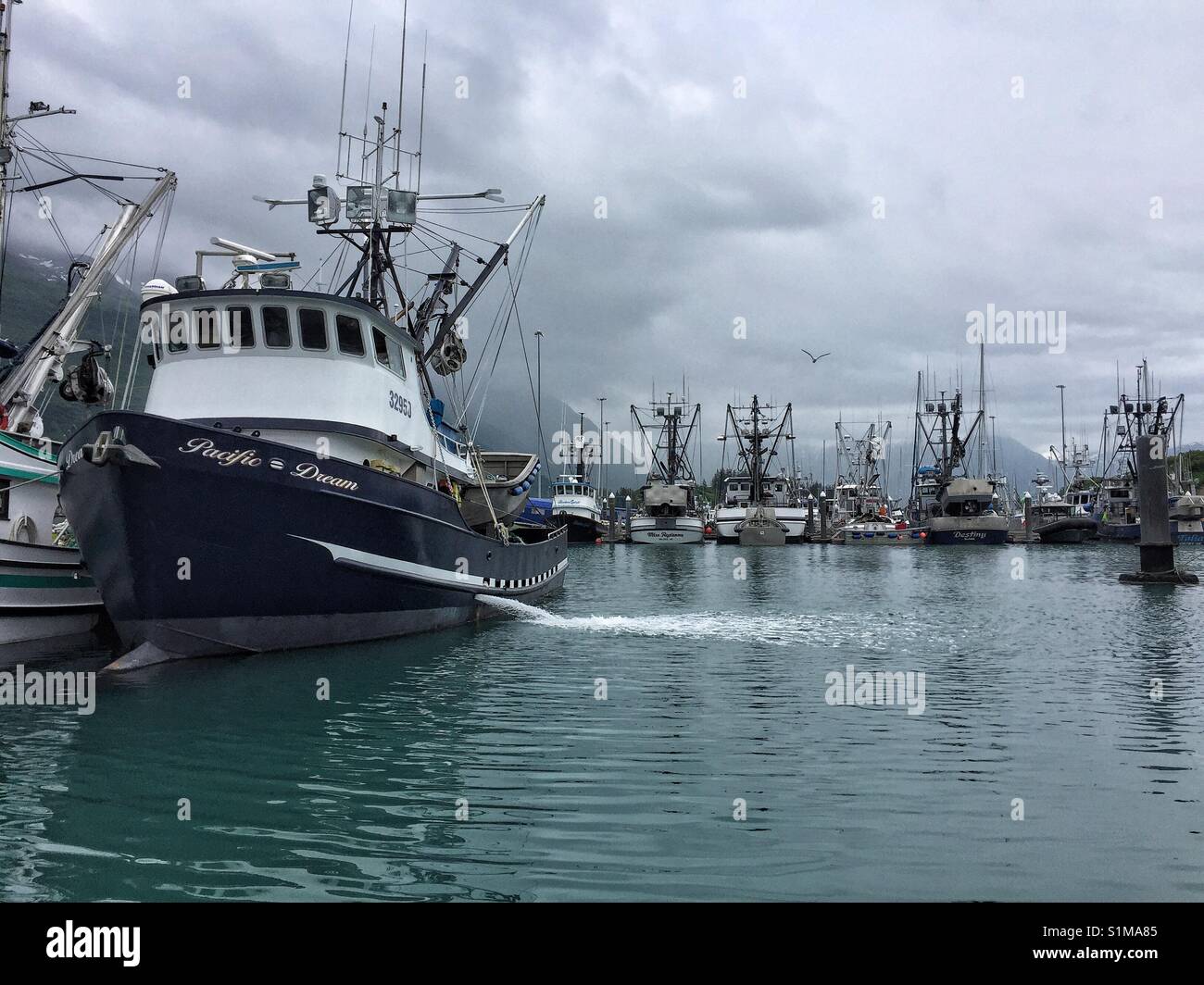 Fishing boats at small boat harbour on cloudy day in Valdez, Alaska, USA Stock Photo