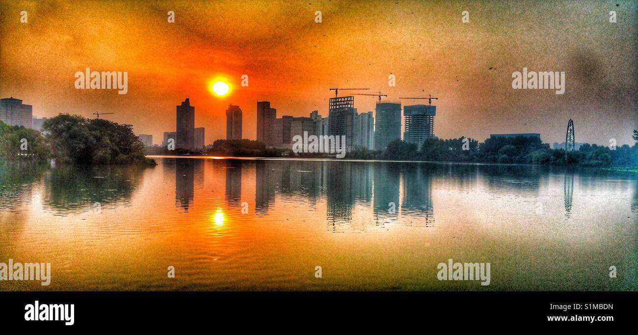 Huai'an, China. Skyline is reflected in the lake. Stock Photo
