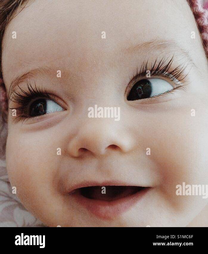 Cute little baby showing her long beautiful eye lashes. Stock Photo