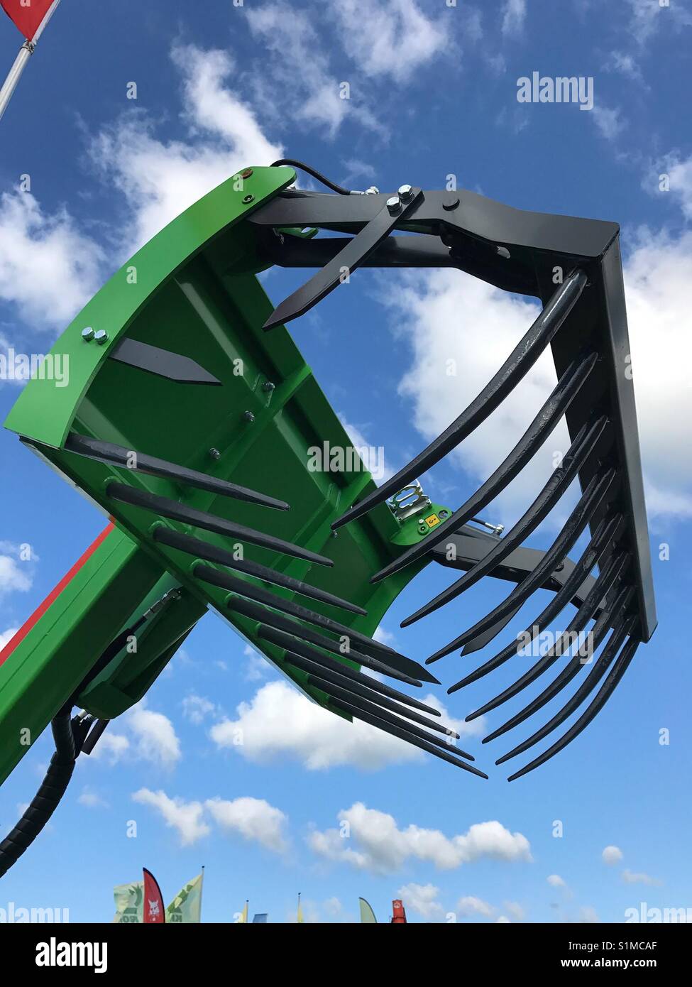 Royal Welsh Show, Builth Wells, Wales - August 2017: The metal jaws of a piece of modern farming machinery - Smartphone Captured Stock Image