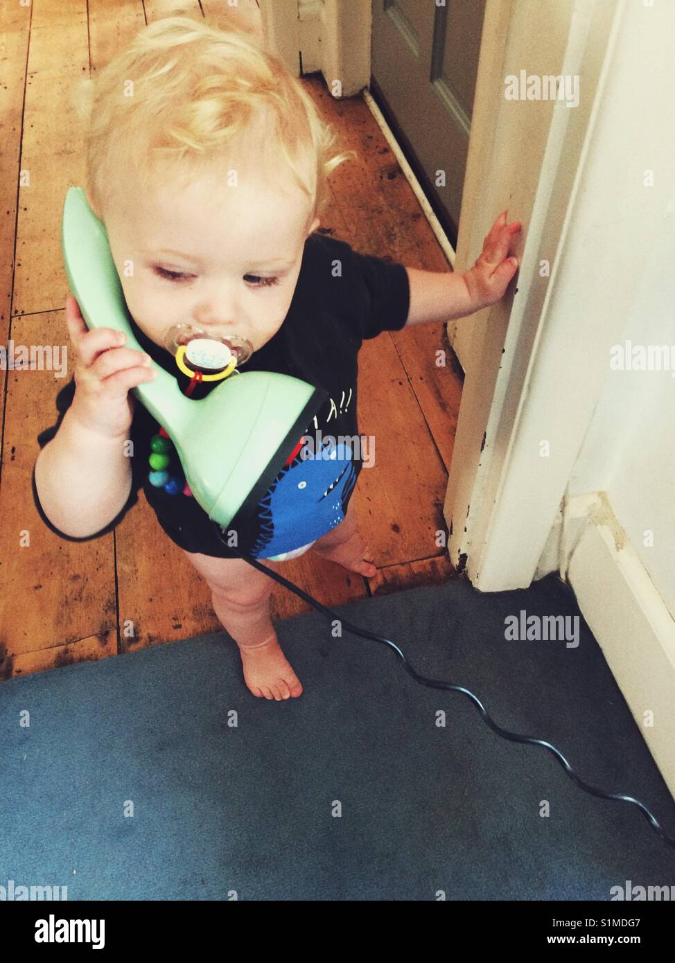 11 month old baby boy on the phone. - Smartphone Captured Stock Image