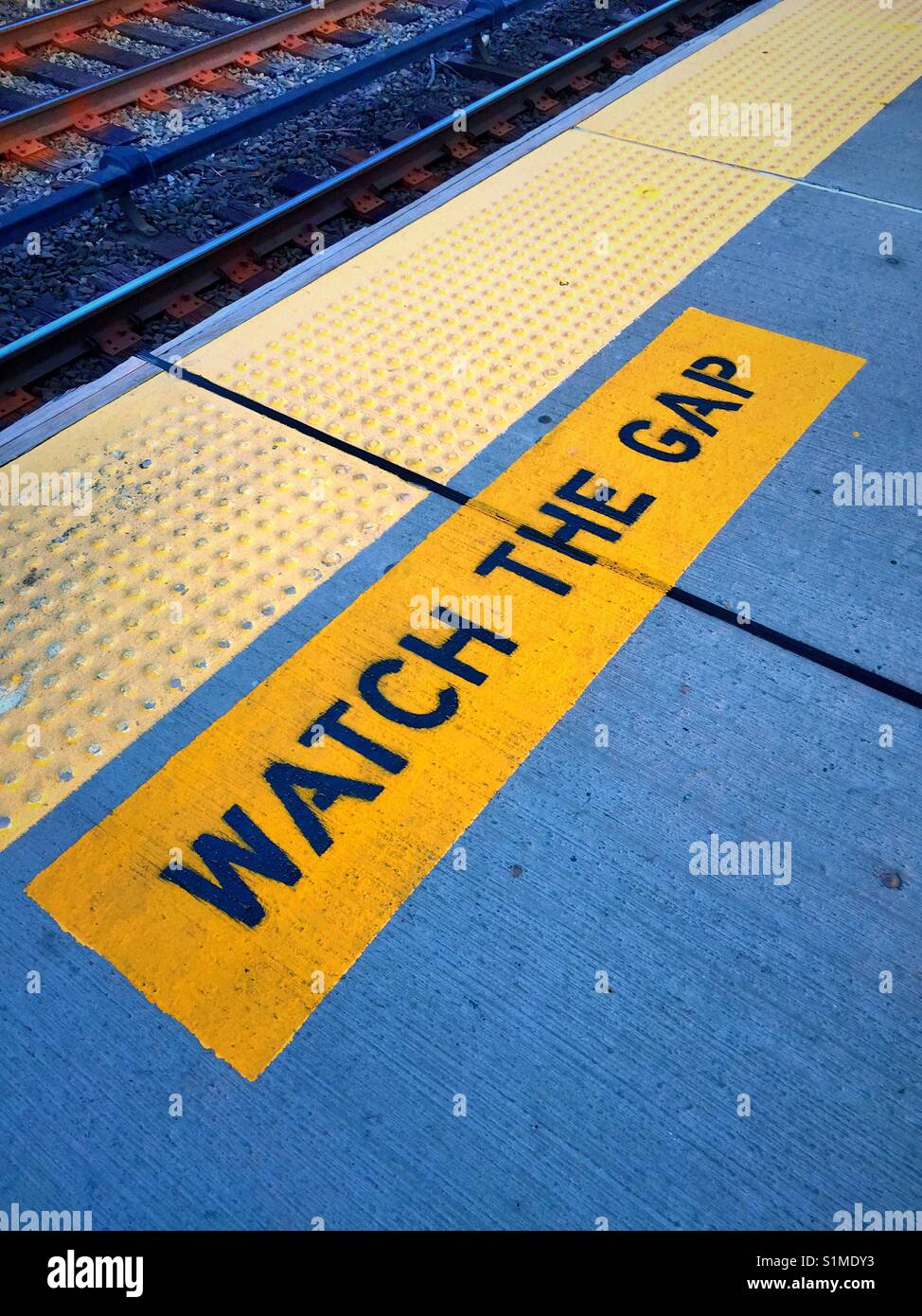 Train platform warning to watch the gap between the subway train and  platform, USA Stock Photo - Alamy