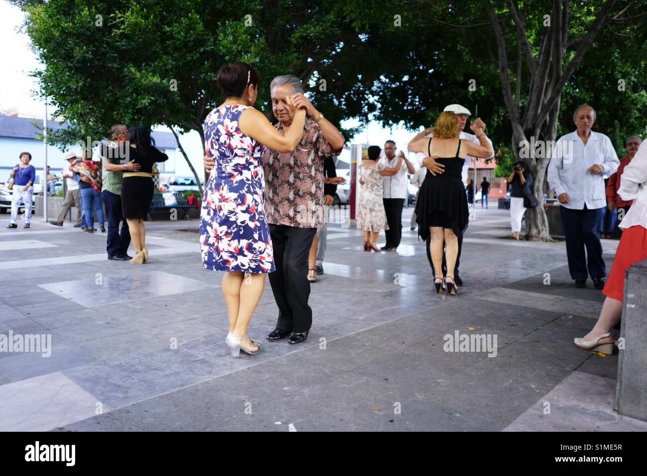 Old people dancing in the park Stock Photo