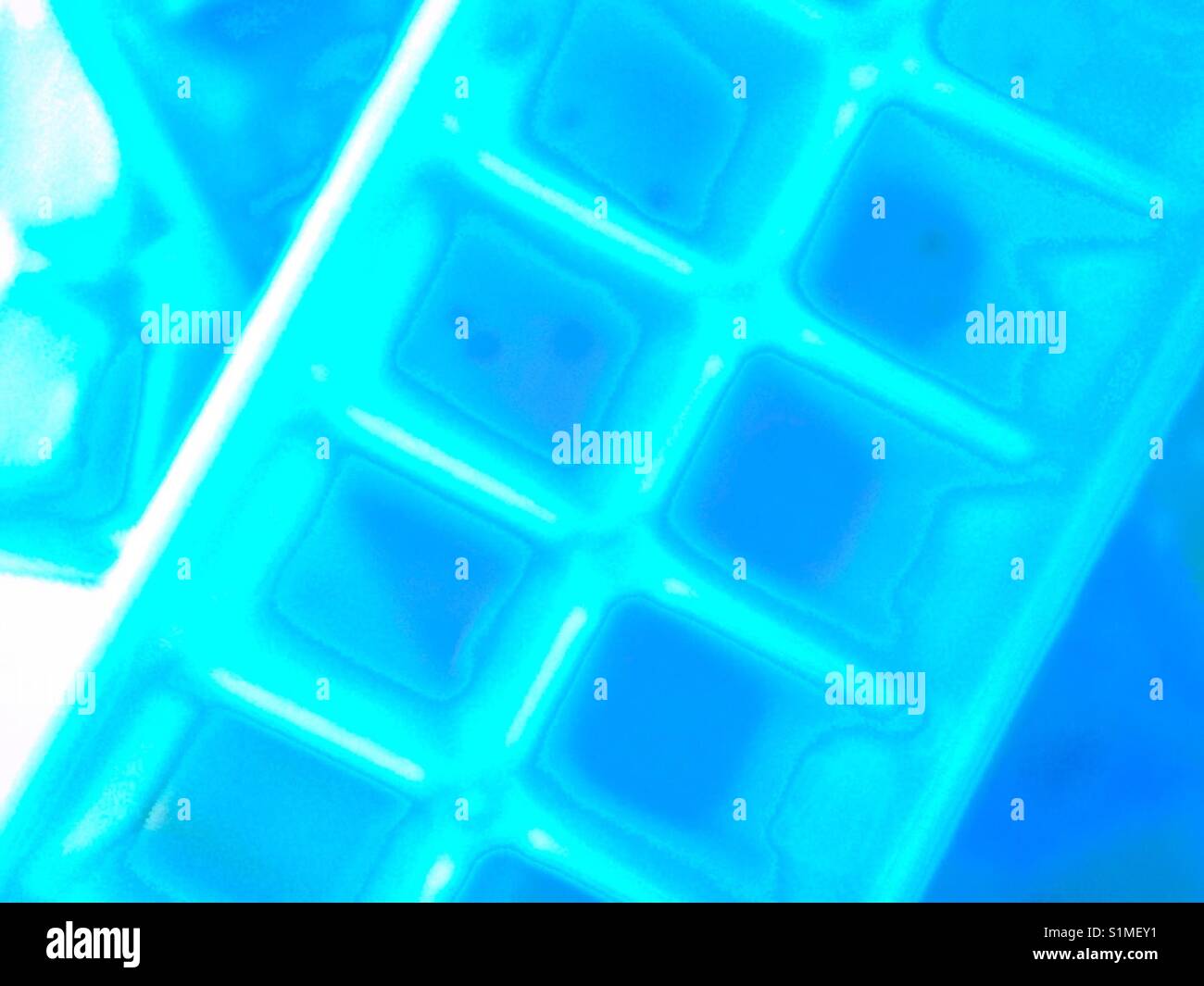 Stack of ice cube trays from top down at thrift shop - Smartphone Captured Stock Image