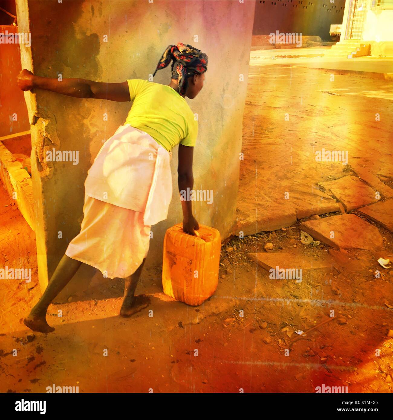 Woman carrying a bucket of water in Pemba, Mozambique, Africa Stock