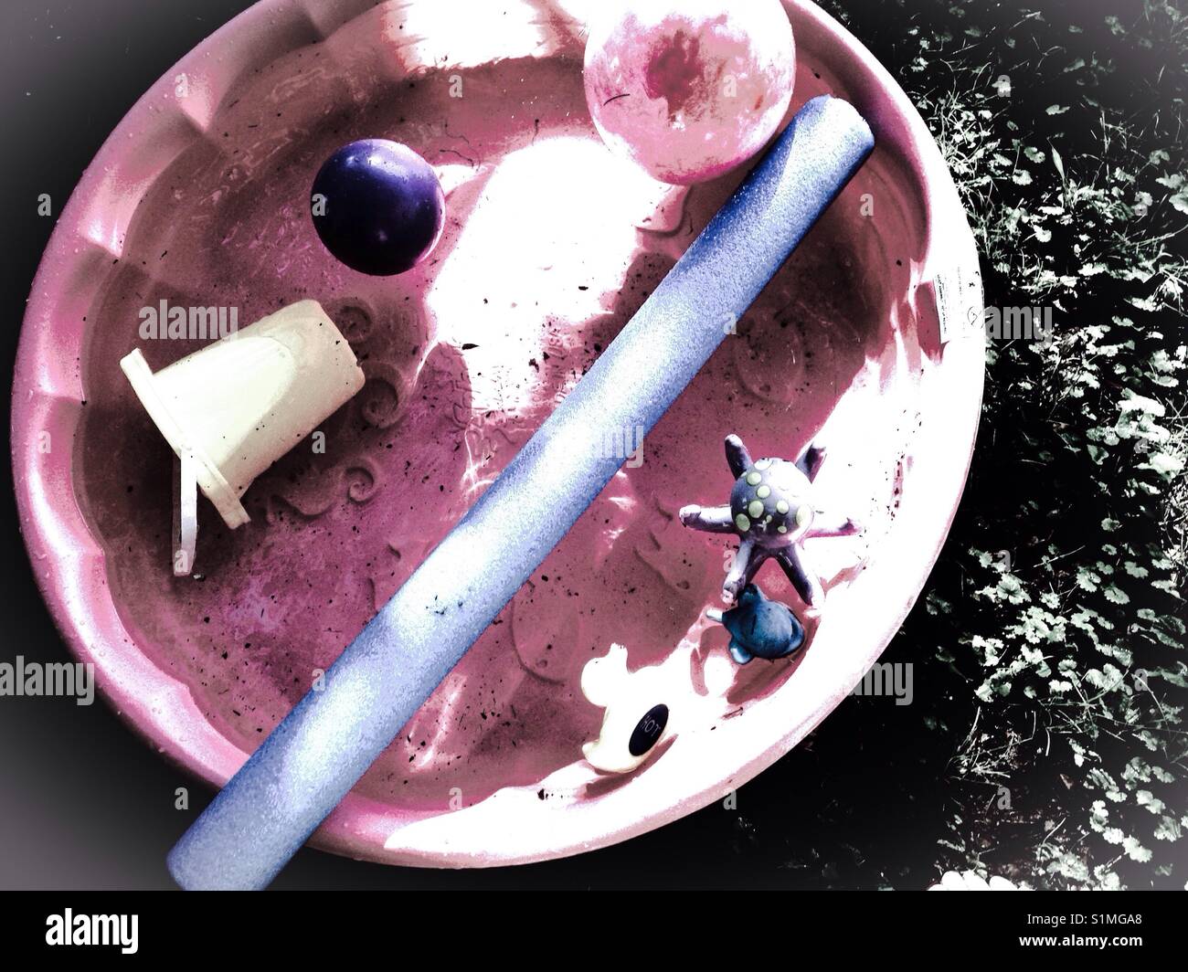 Just add water- child's pink wading pool with toys, sans water - Smartphone Captured Stock Image