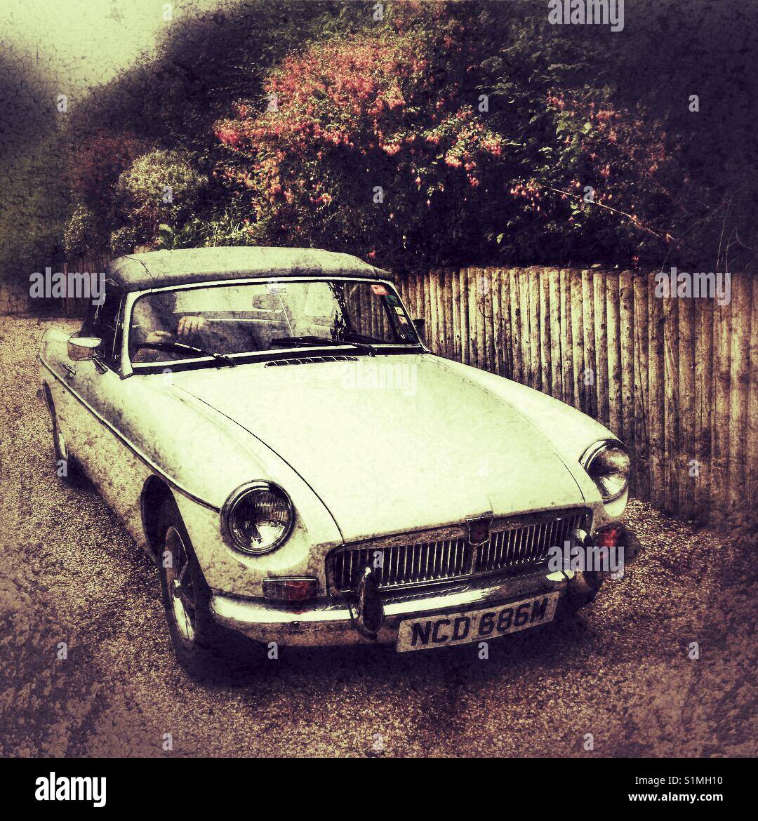 MGB Roadster, 1973, woman at the wheel, parking car - Smartphone Captured Stock Image