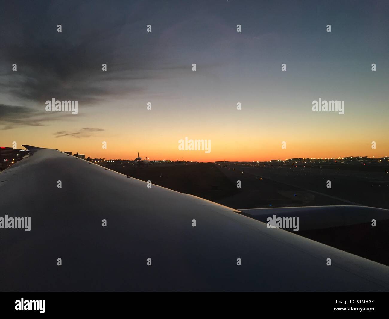 March 2017 - Landscape view over wing departing Los Angeles airport at sunset - Smartphone Captured Stock Image