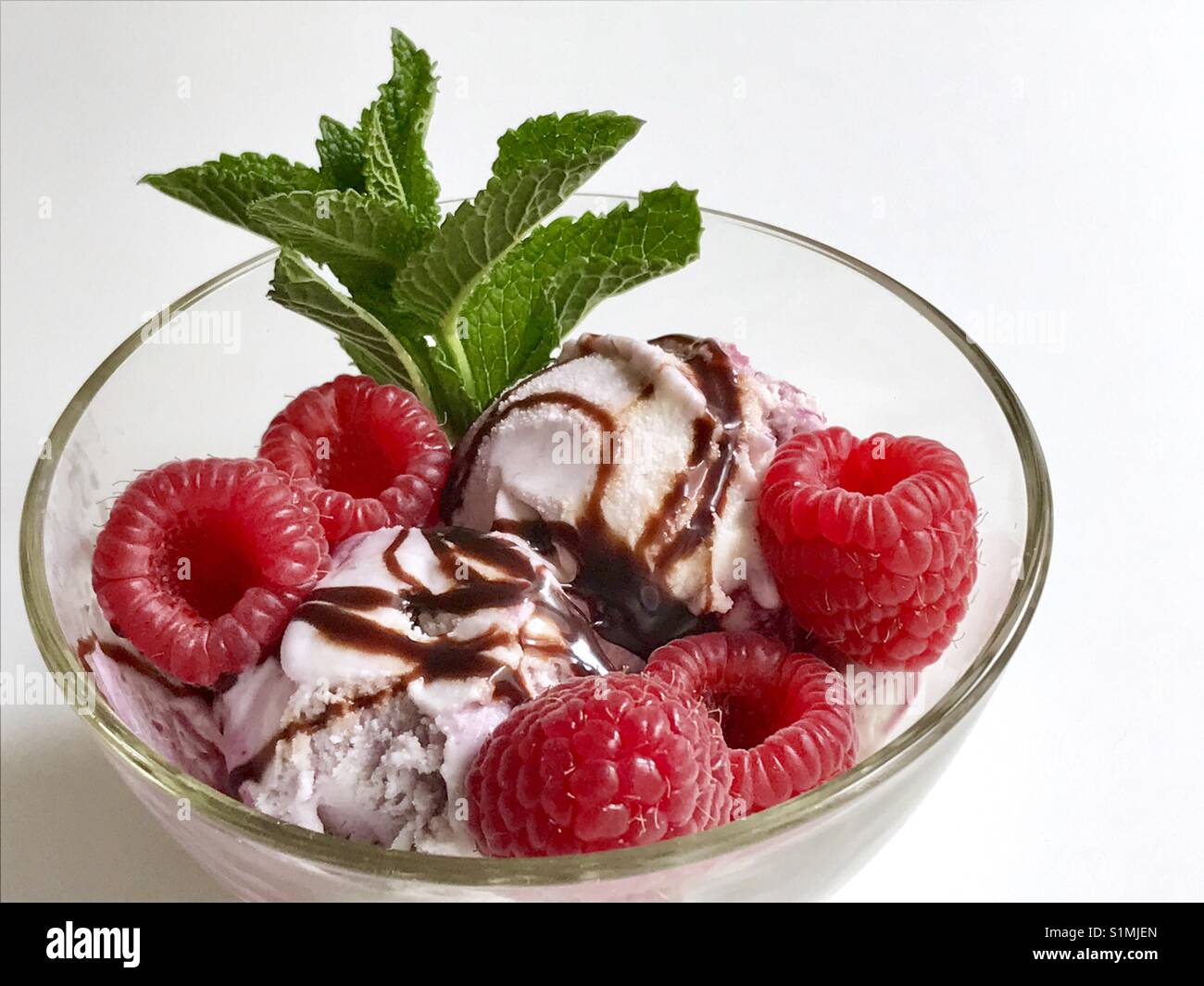 Ice cream with raspberries and mint leaves. - Smartphone Captured Stock Image