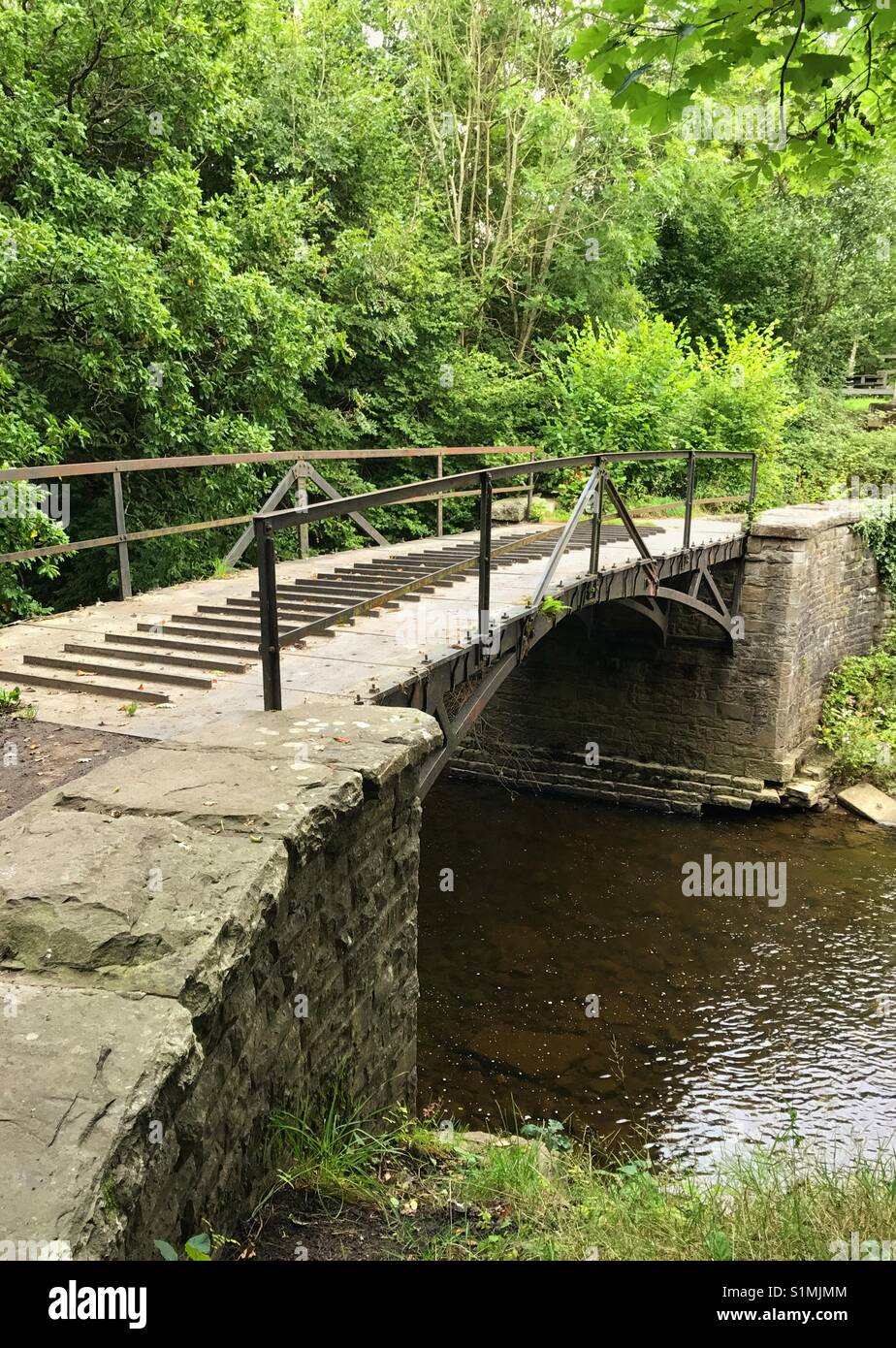 The cast iron tram road bridge over the River Cynon in Aberdare, Wales, was built in 1811 and is one of the oldest 'railway' bridges in the world Stock Photo