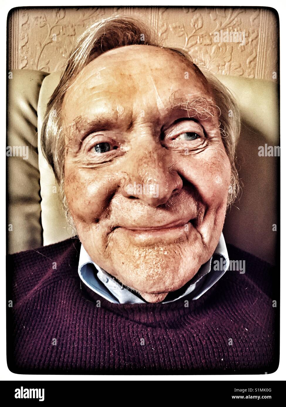 Elderly man relaxing at home - Smartphone Captured Stock Image