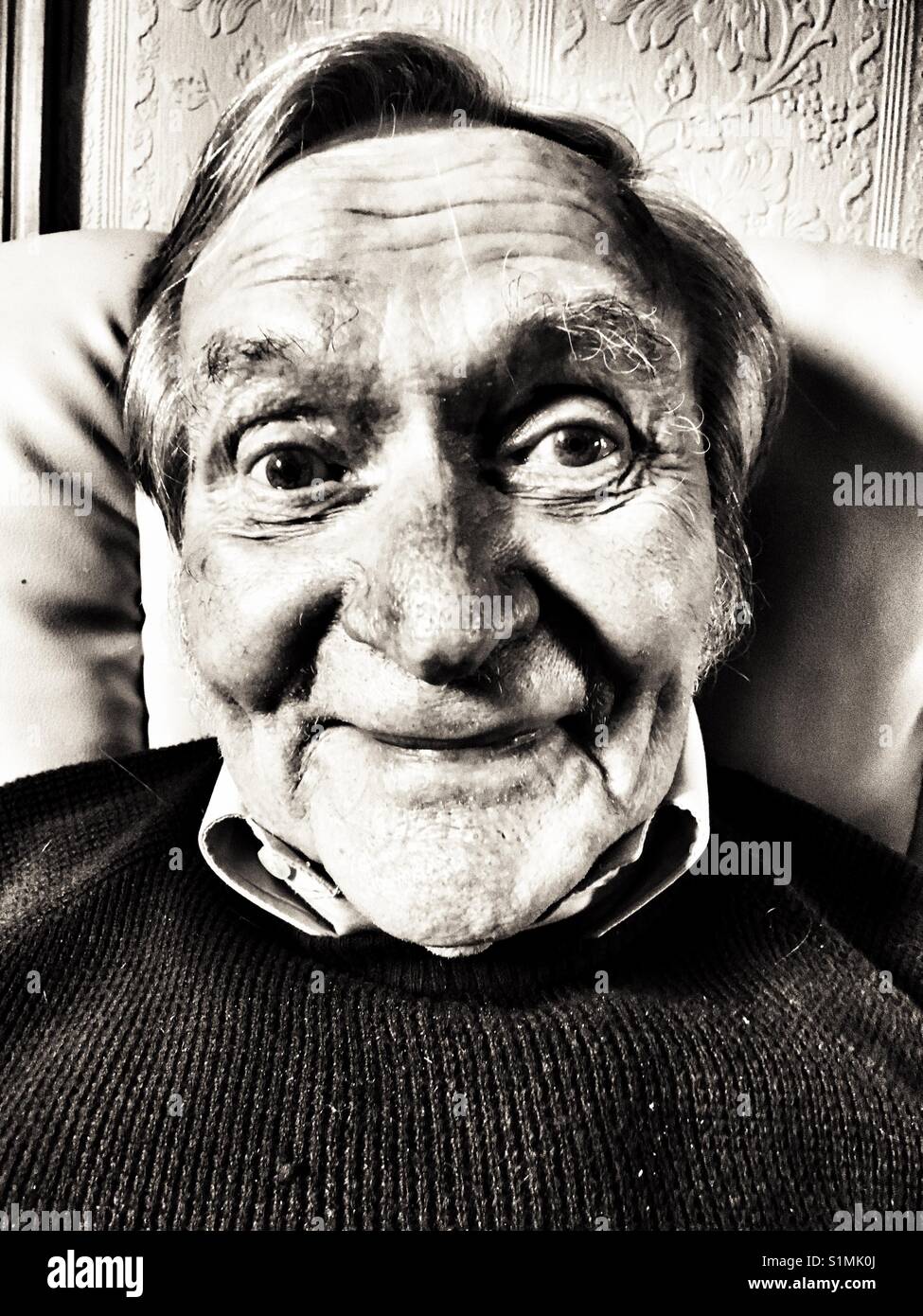 Elderly man relaxing at home - Smartphone Captured Stock Image