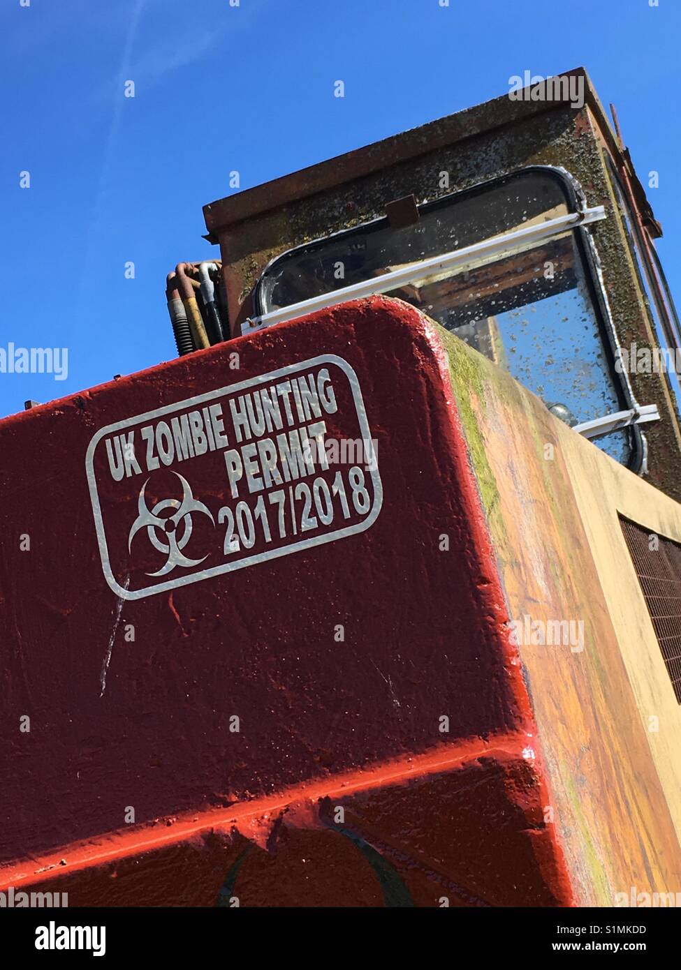 Zombie Hunting Permit on back of excavator, Robin Hood's Bay, N Yorkshire, UK - Smartphone Captured Stock Image