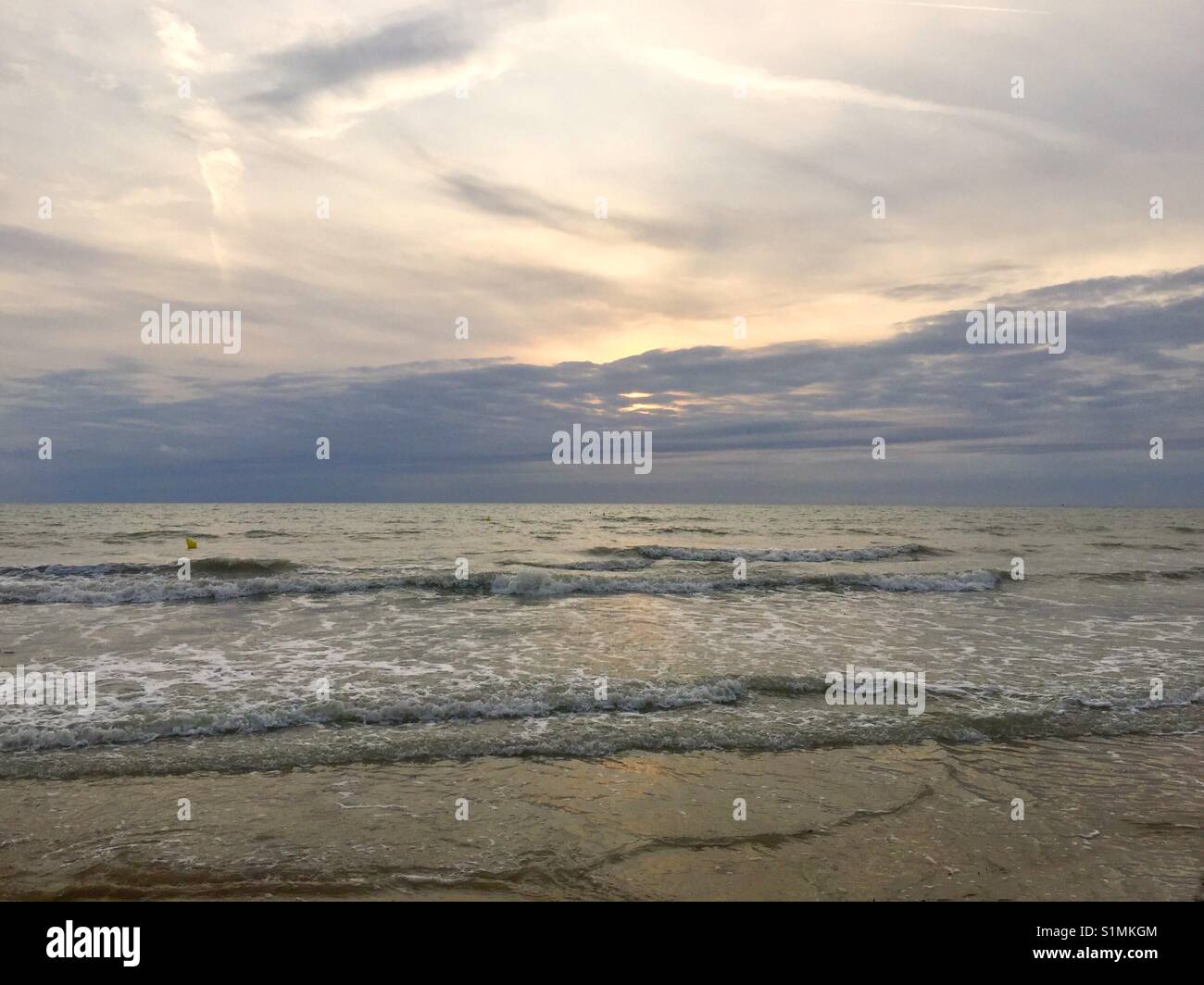 Waves hitting a Normandy beach Stock Photo