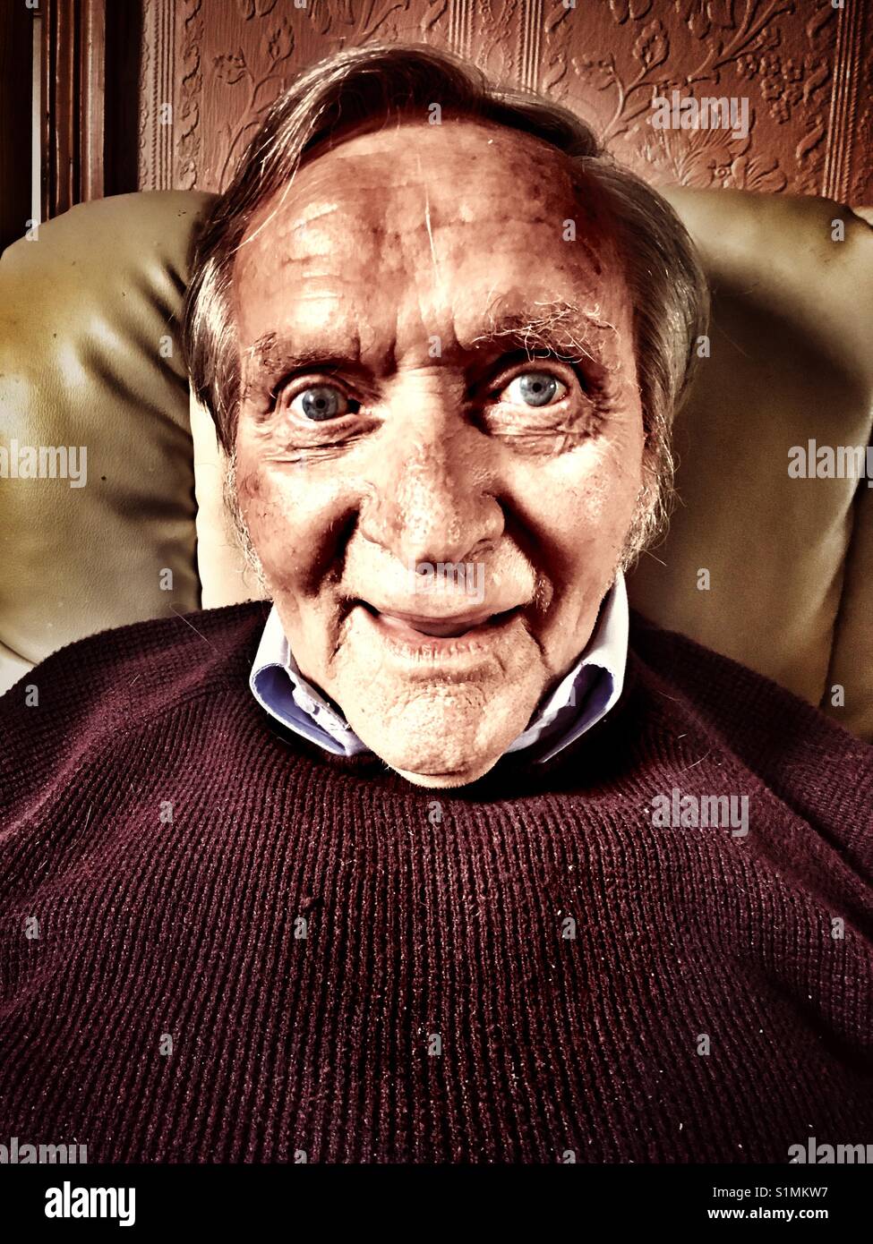 Elderly man relaxing at home - Smartphone Captured Stock Image