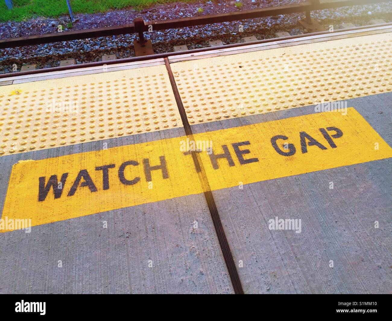 Train platform warning to watch the gap between the subway train and platform, USA, Stock Photo
